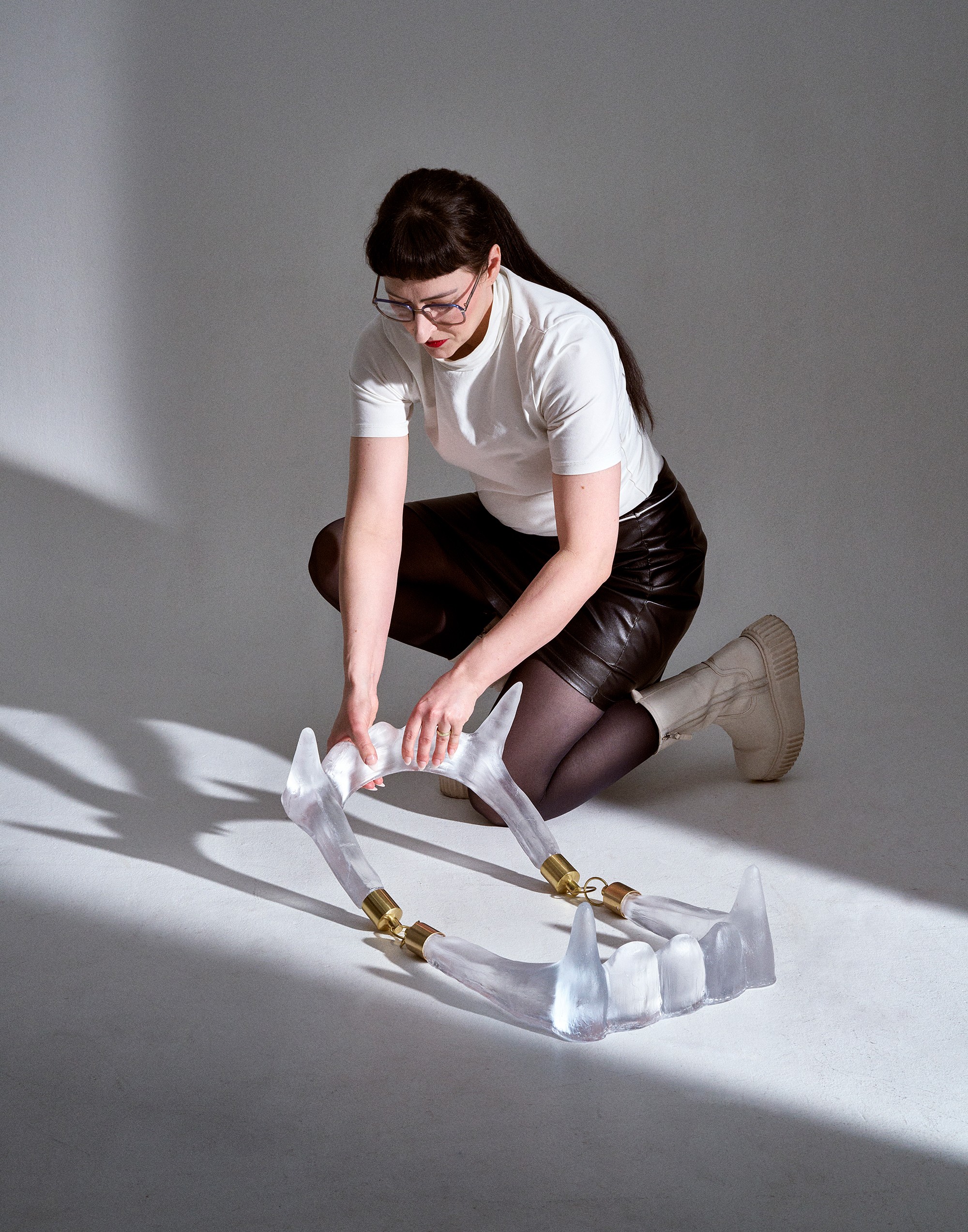 Matilda Kästel with glass sculpture Endo — glass teeth piece with brass fittings