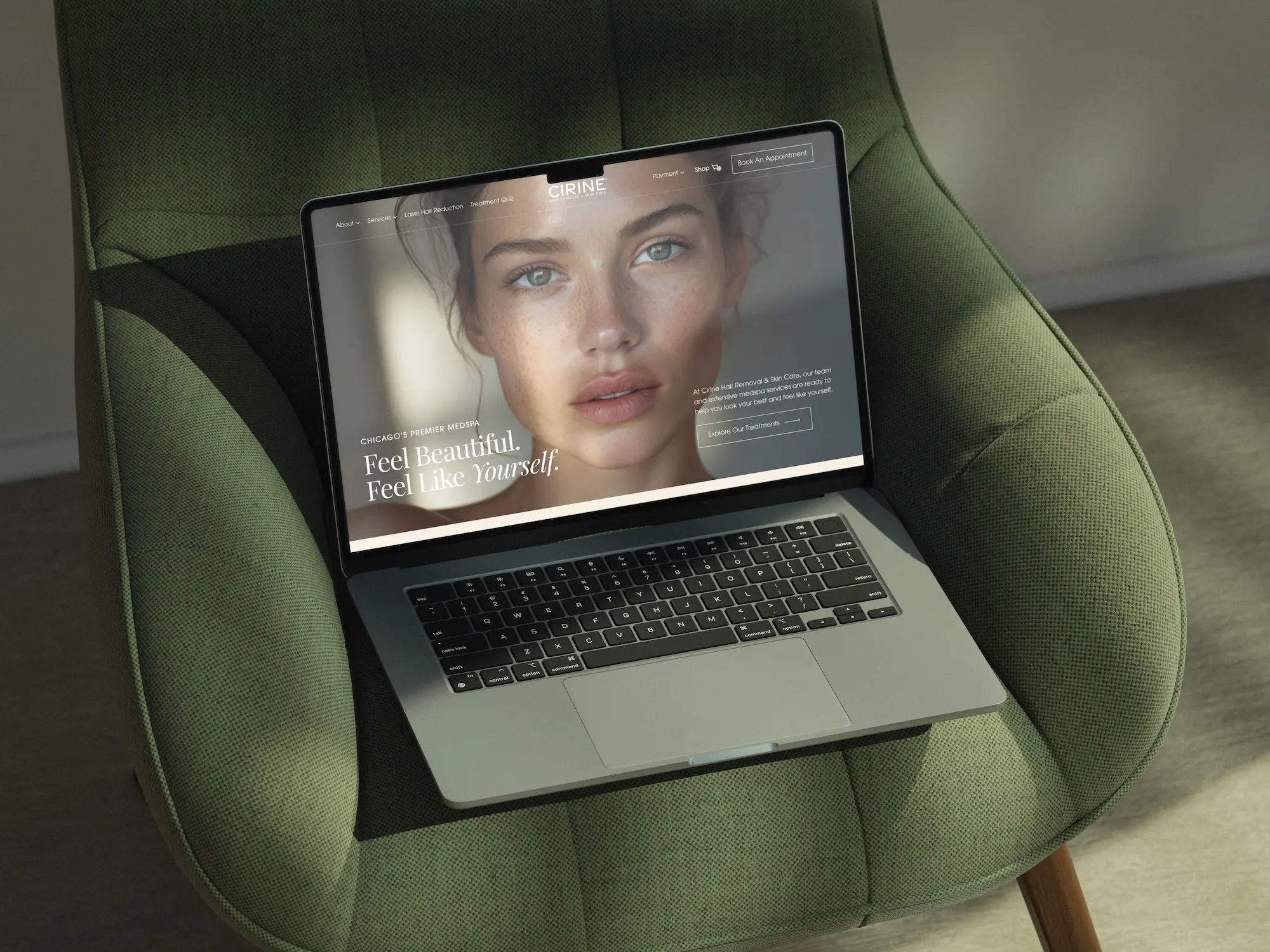 A laptop sits on a green chair, displaying a close-up of a person's face on the screen.
