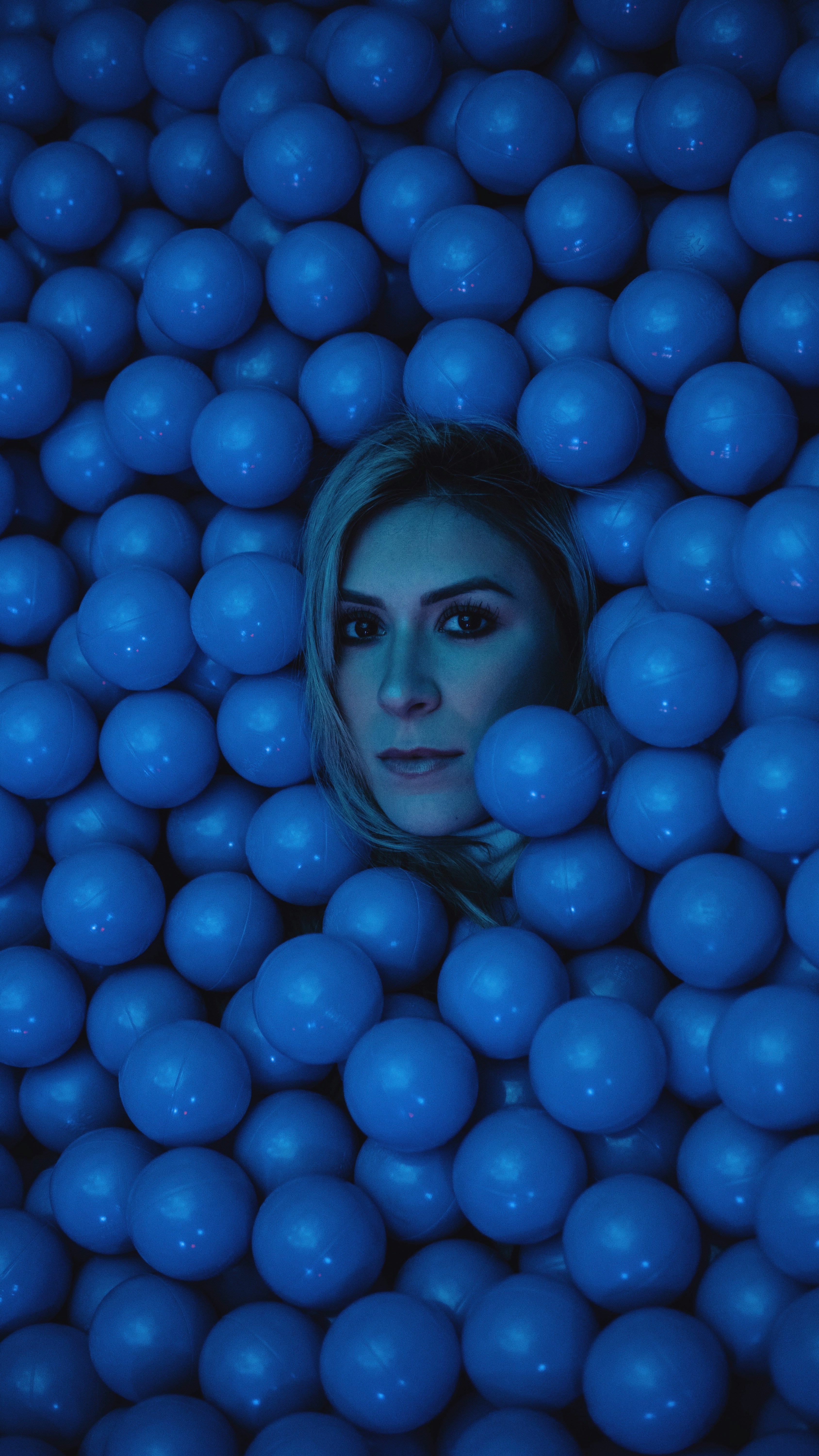 woman's face surrounded by blue balls