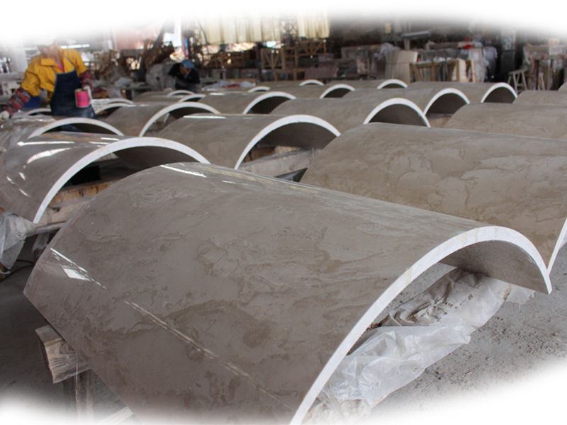 Rows of polished stone arc slabs ready for installation, demonstrating the Stone Arc-Slab Polishing Machine's capability to produce large volumes with consistent quality.