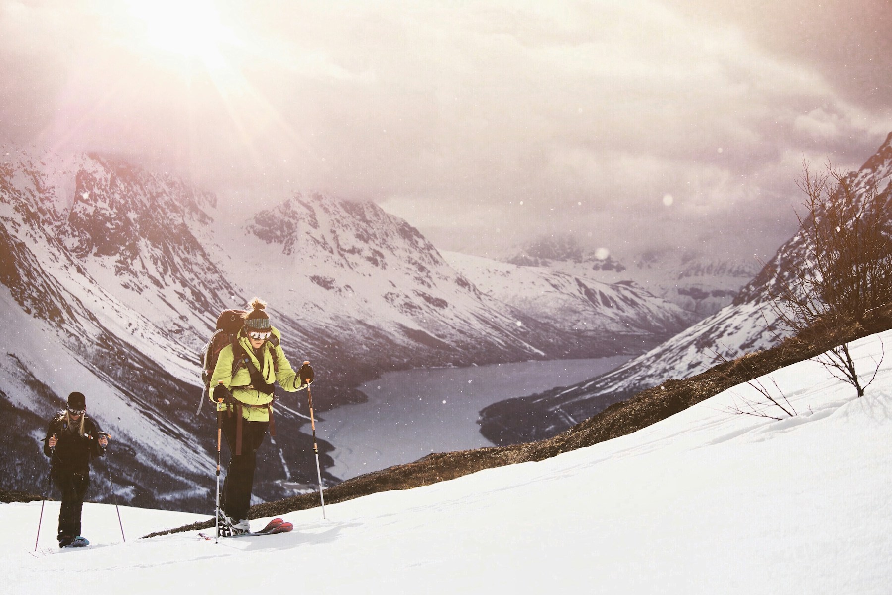 a couple of people stand on snow skis — Lyngseidet, Norway