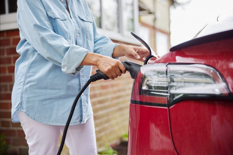 A woman charging electric car