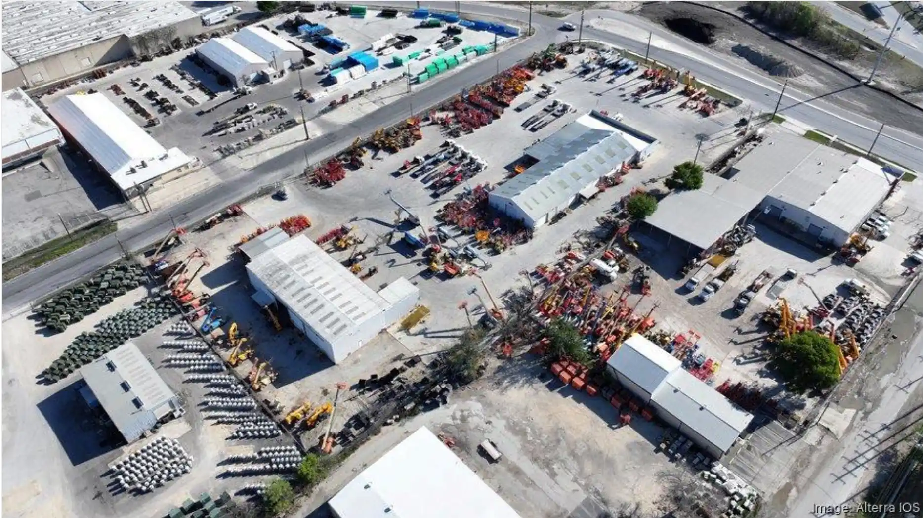 Aerial view of an industrial outdoor storage yard filled with construction equipment