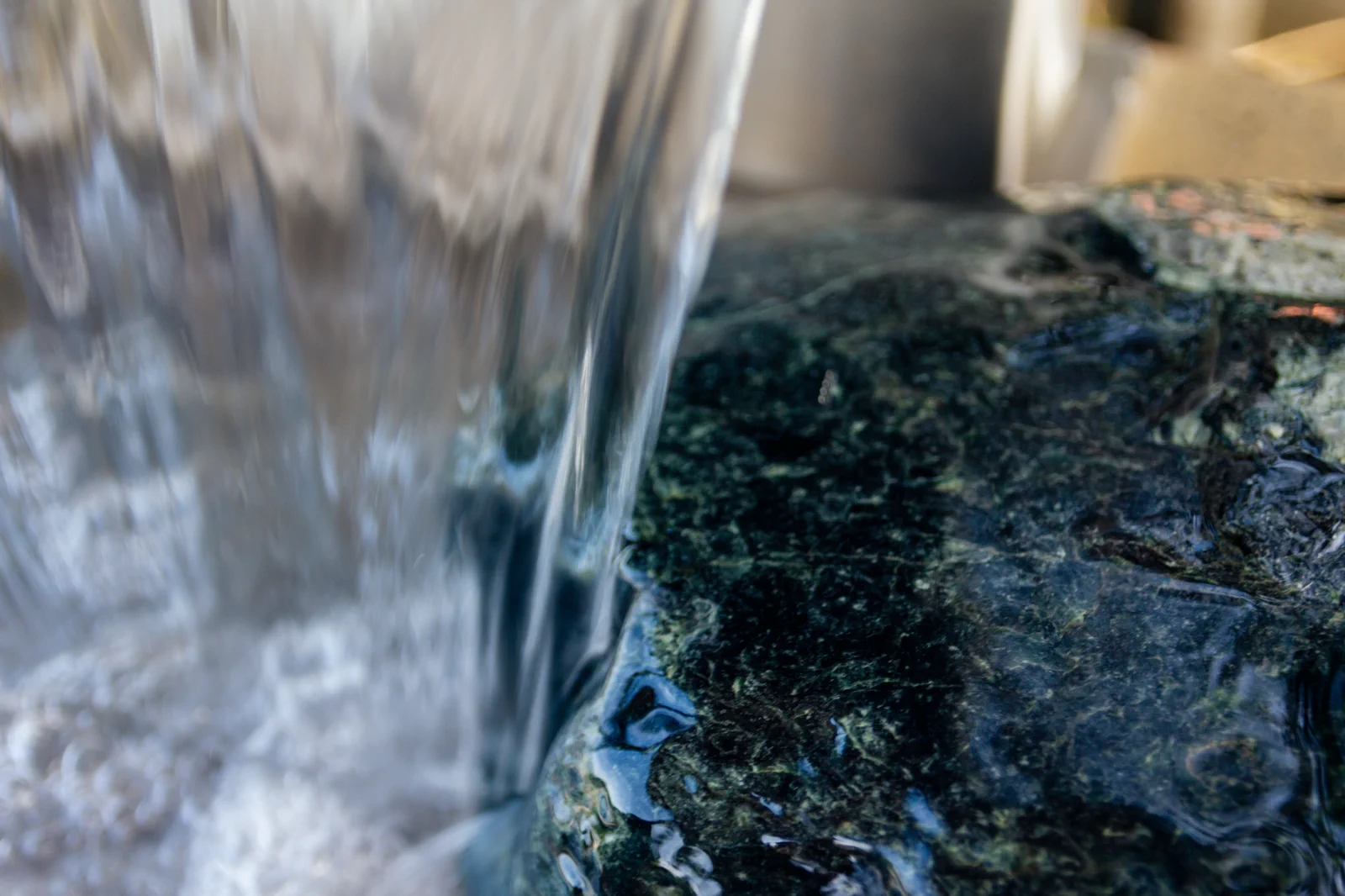 Water flowing over dark stone
