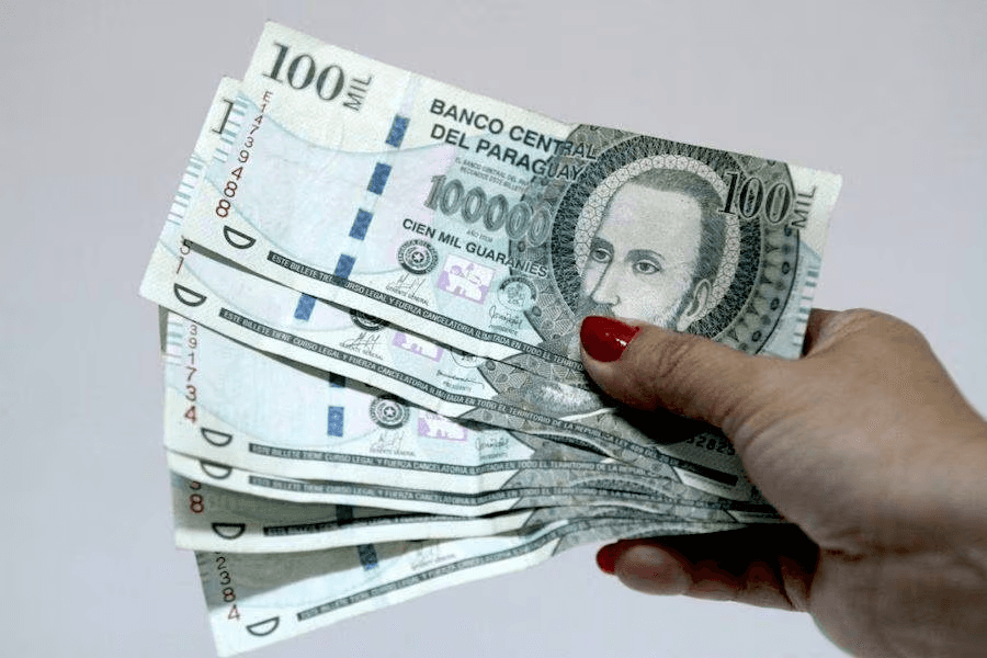 Mano sosteniendo guaranies