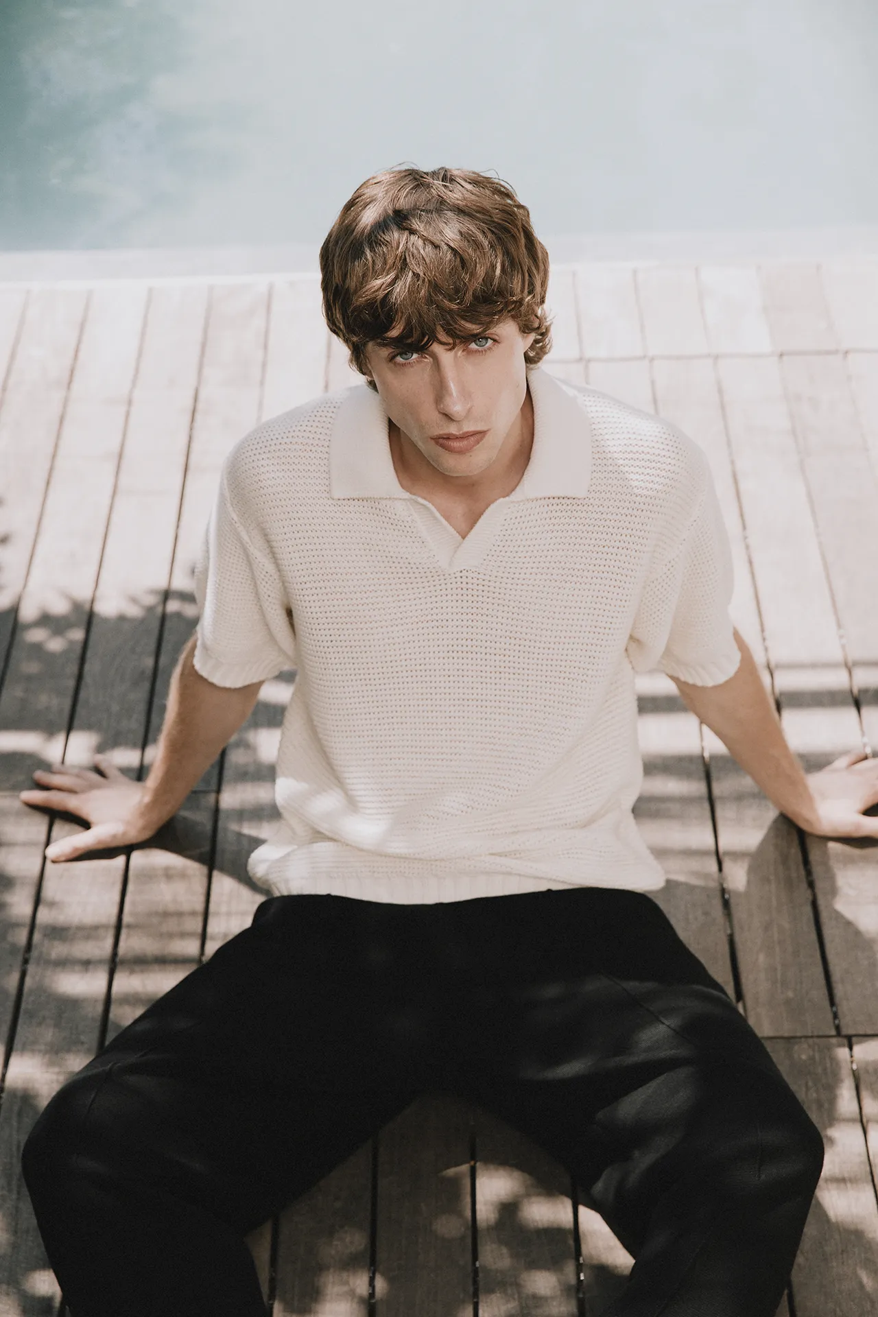 Annapurna SS26 collection men's white textured knit polo shirt with short sleeves.