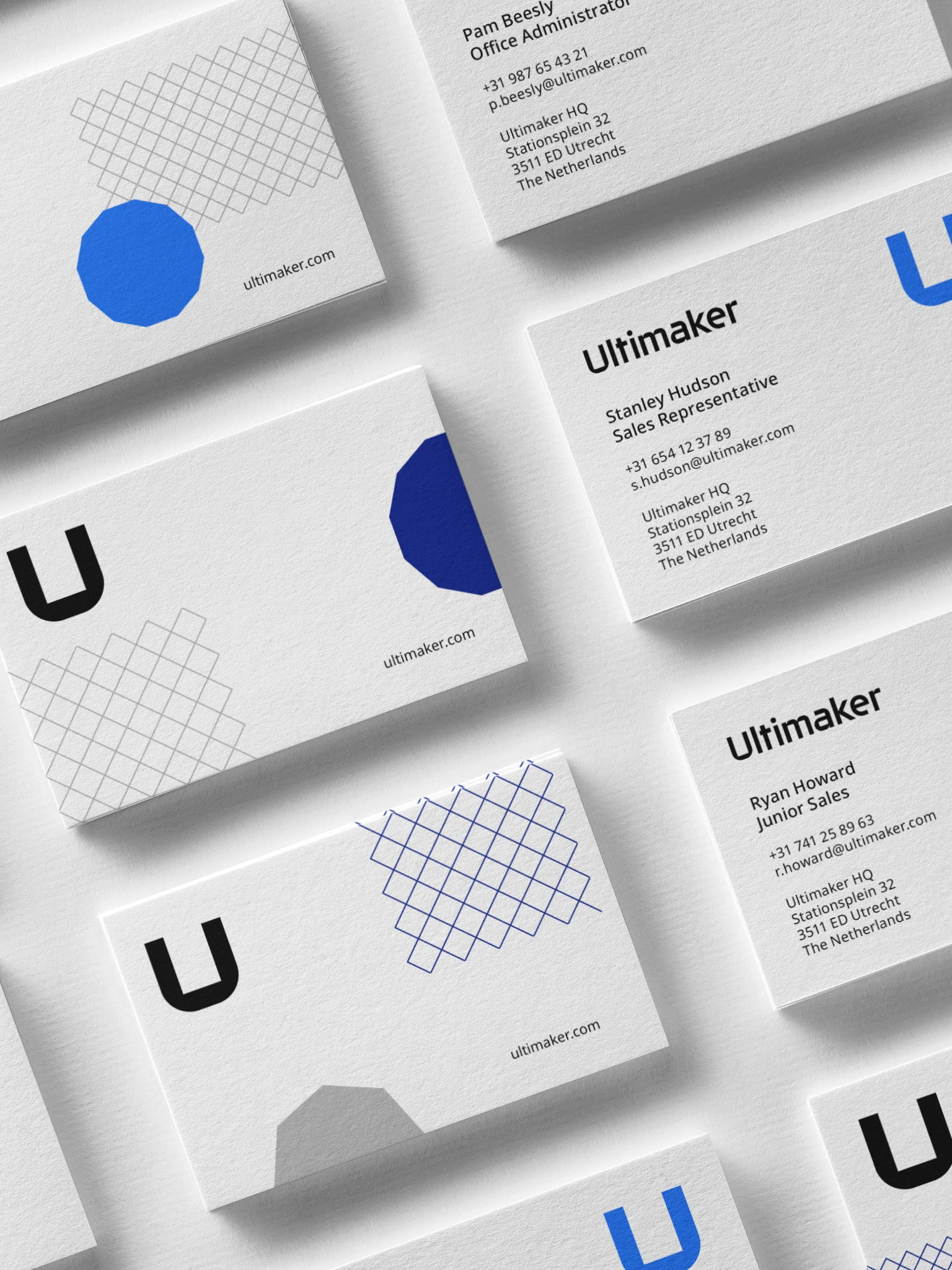 Modern home office setup with a monitor, ergonomic chair, keyboard, and indoor plants near a window with blinds.