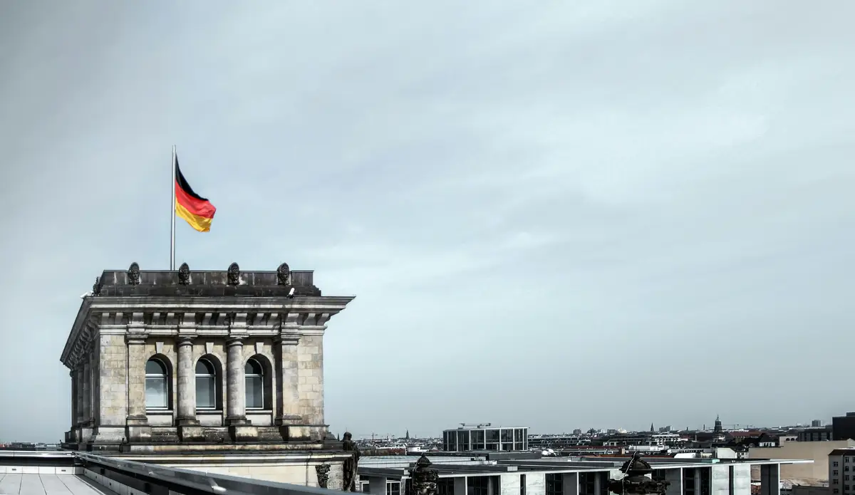 German flag flying above the Reichstag building in Berlin
