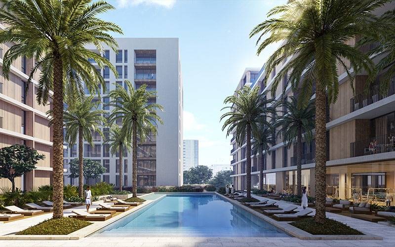 A serene swimming pool surrounded by vibrant palm trees, set in the tranquil environment of Park Point.