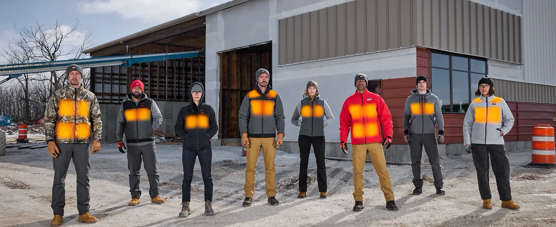 Group of construction people wearing Heated Jackets on a Construction Site in winter.
