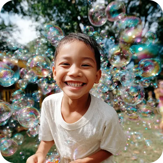A joyful child smiles broadly, surrounded by iridescent bubbles in a sunlit garden, conveying a sense of happiness and playfulness.