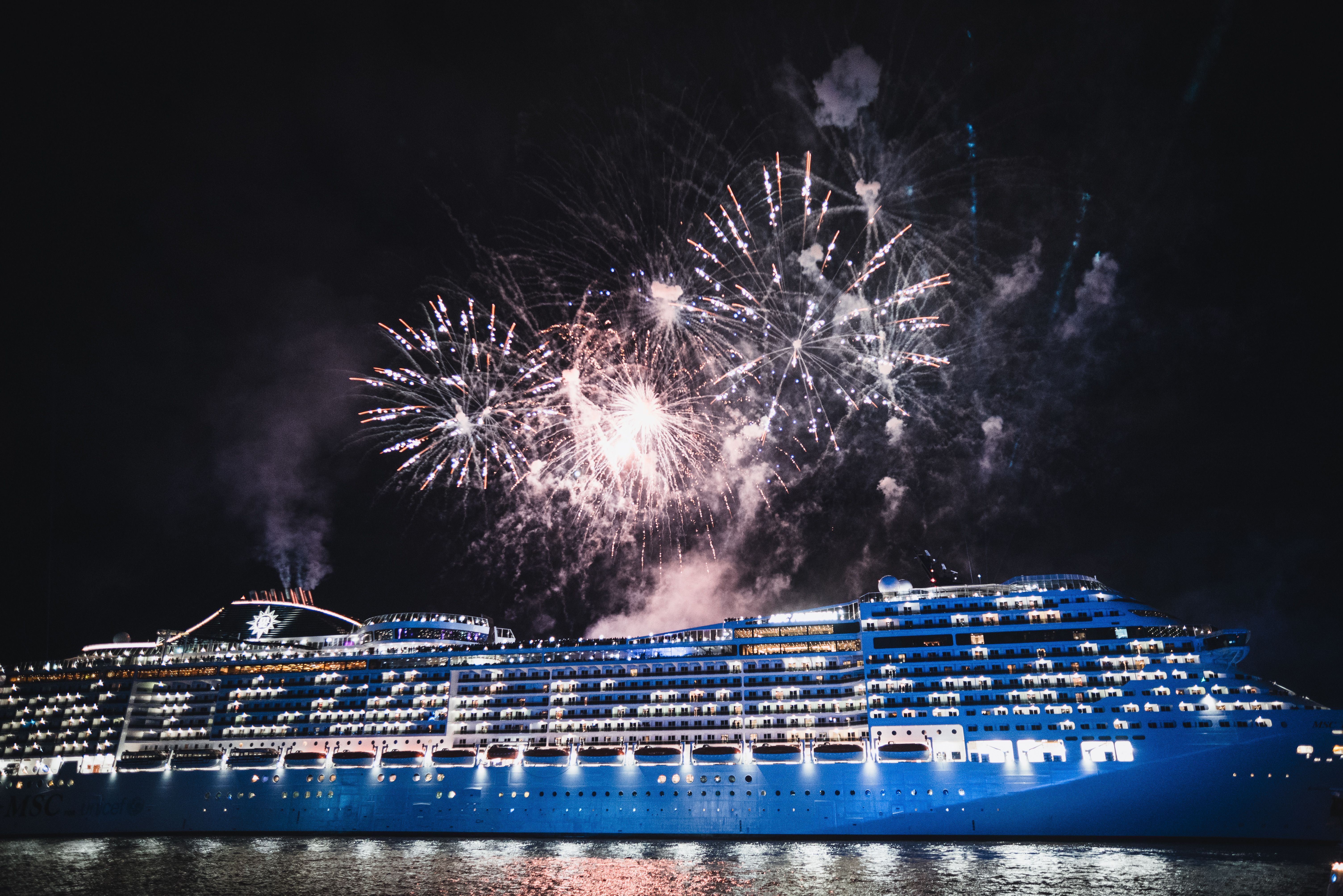 cruise ship at night with fireworks