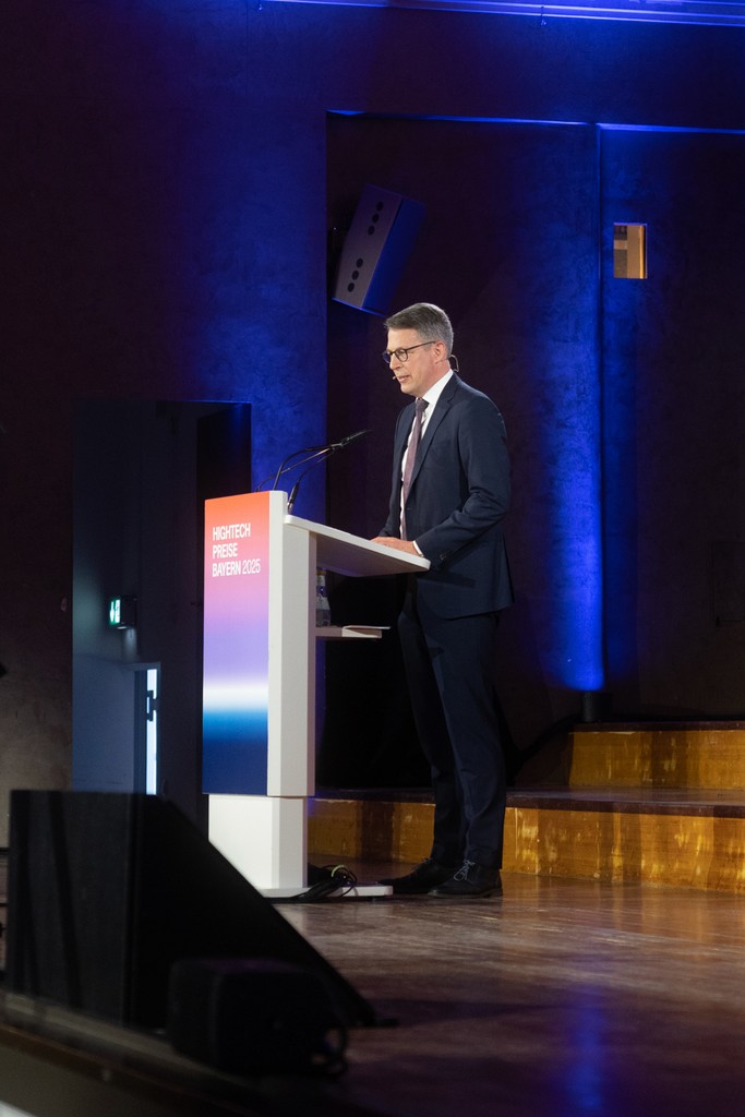Businessman speaking at a podium during a professional event