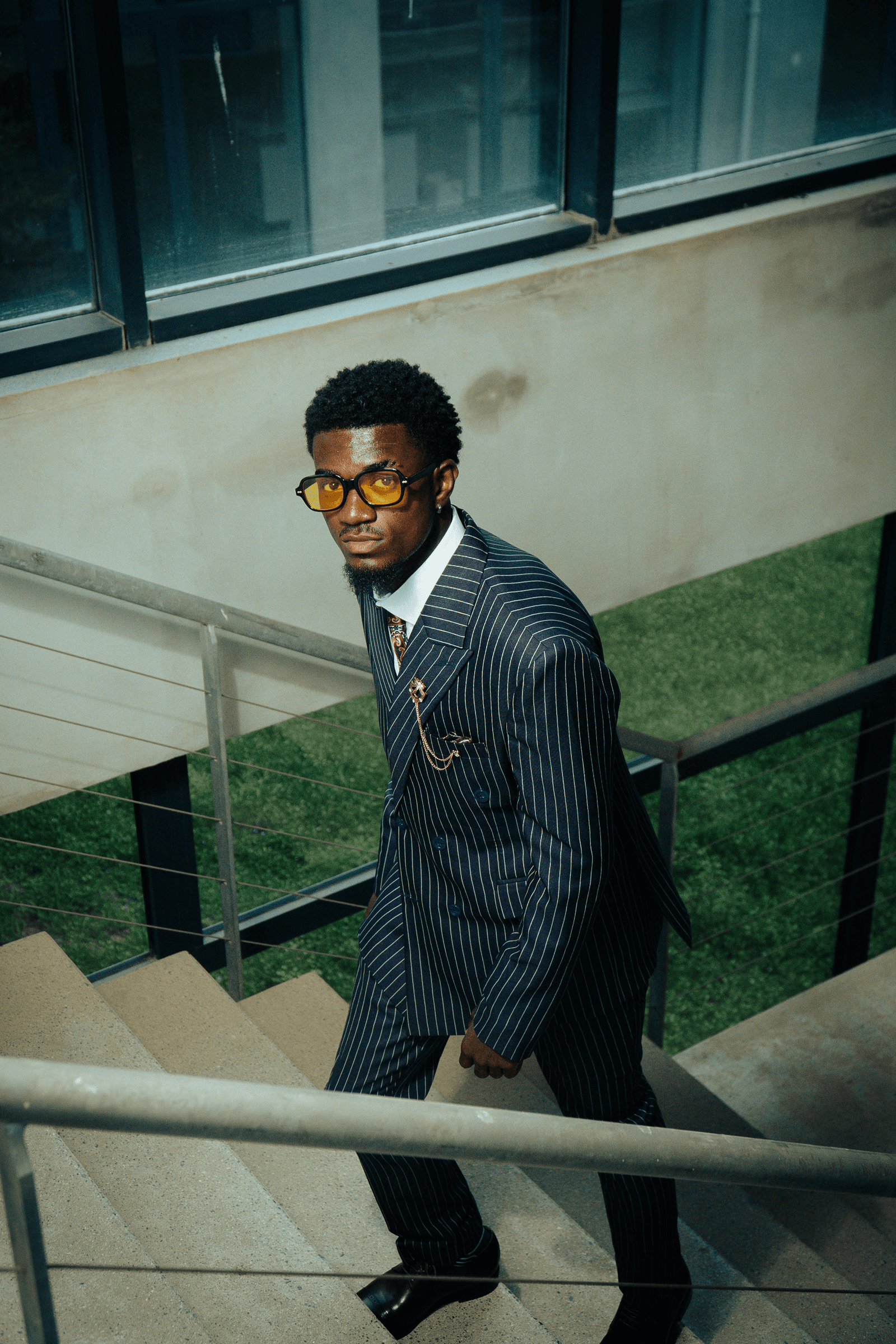 Man in suit ascending stairs.