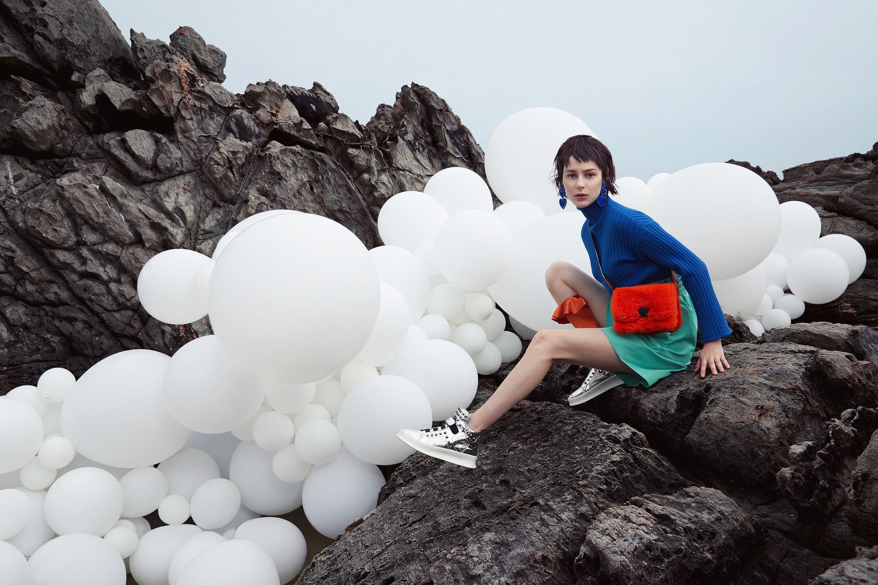  Collaborative work session overhead view of six people collaborating at a rustic wooden table with coffee, papers, and a laptop