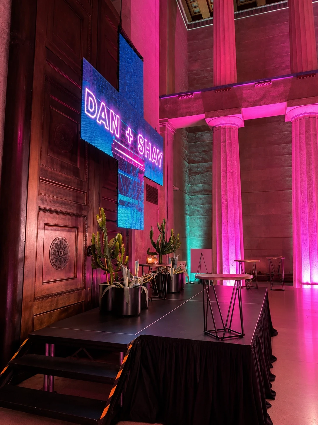 'Dan + Shay' LED screen with magenta uplighting on the Parthenon columns, Nashville — concert production by UpLight Technologies