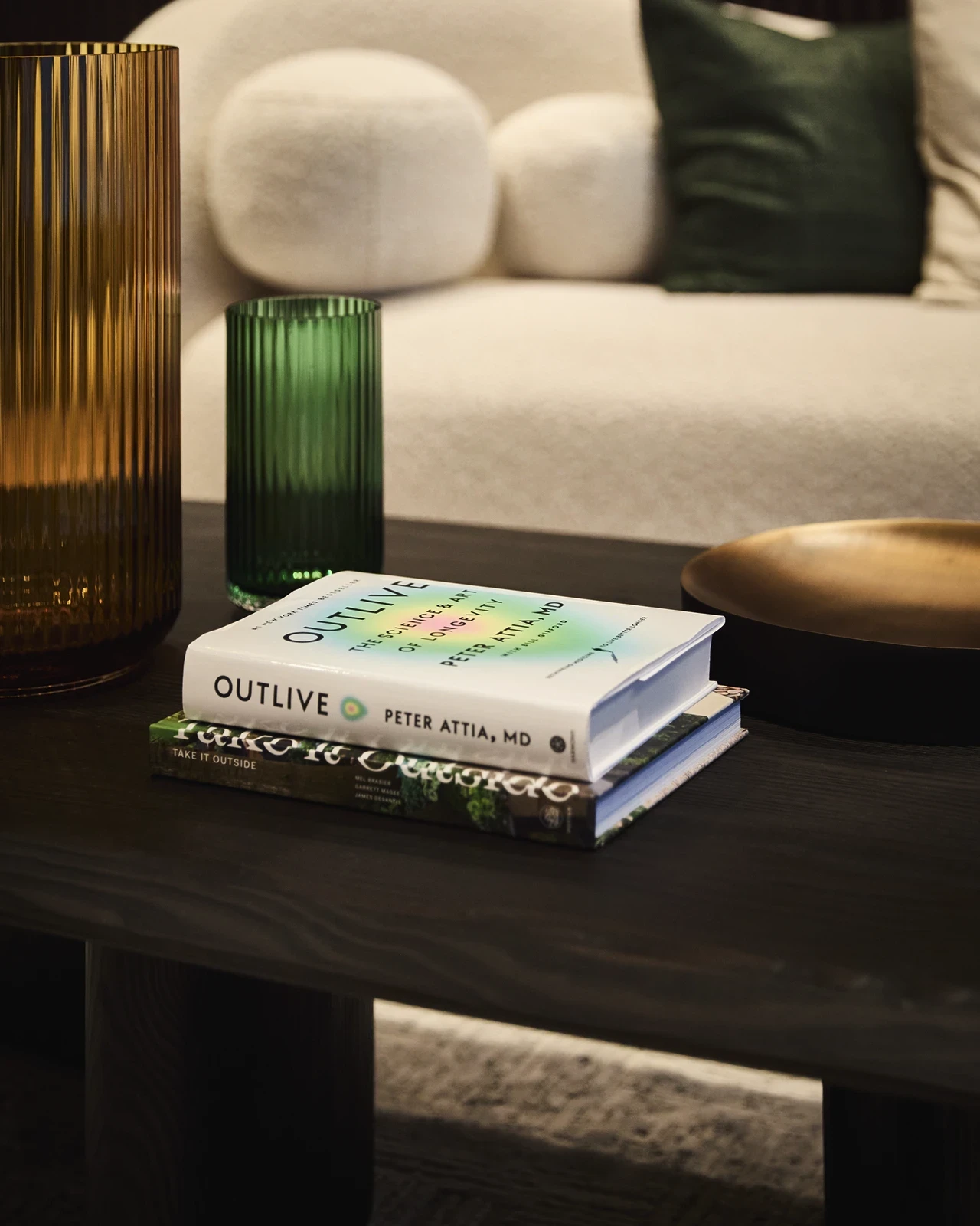 Coffee table in Biograph New York private suite featuring Outlive by Peter Attia, reflecting the clinic’s longevity-focused design.