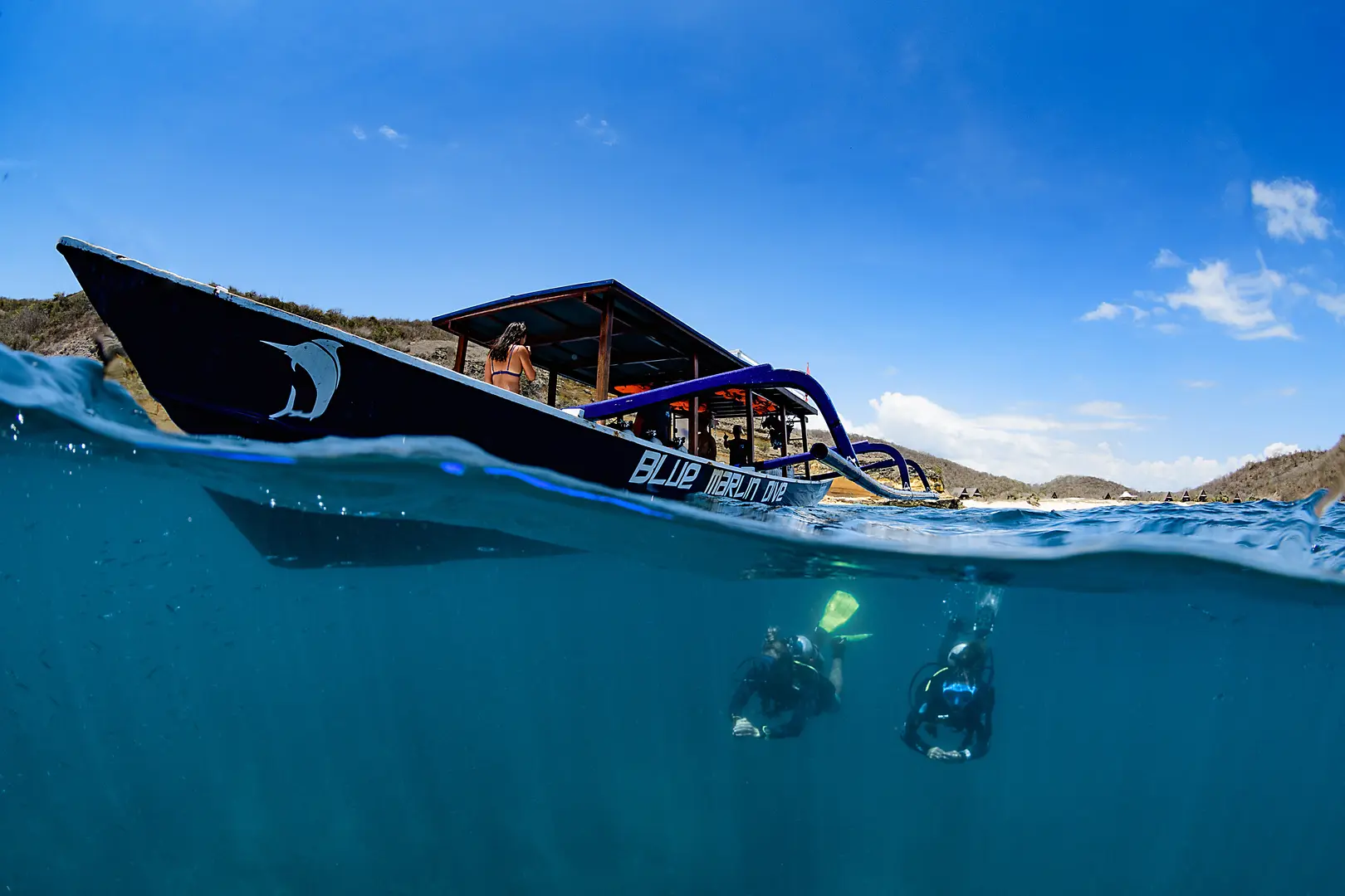 Blue marlin boat with divers below the surface