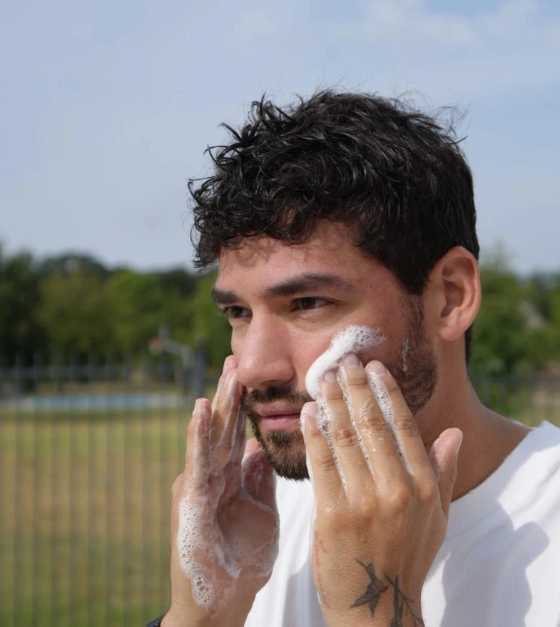 Man applying gentle facial cleanser to remove buildup and impurities for smoother, refreshed skin.