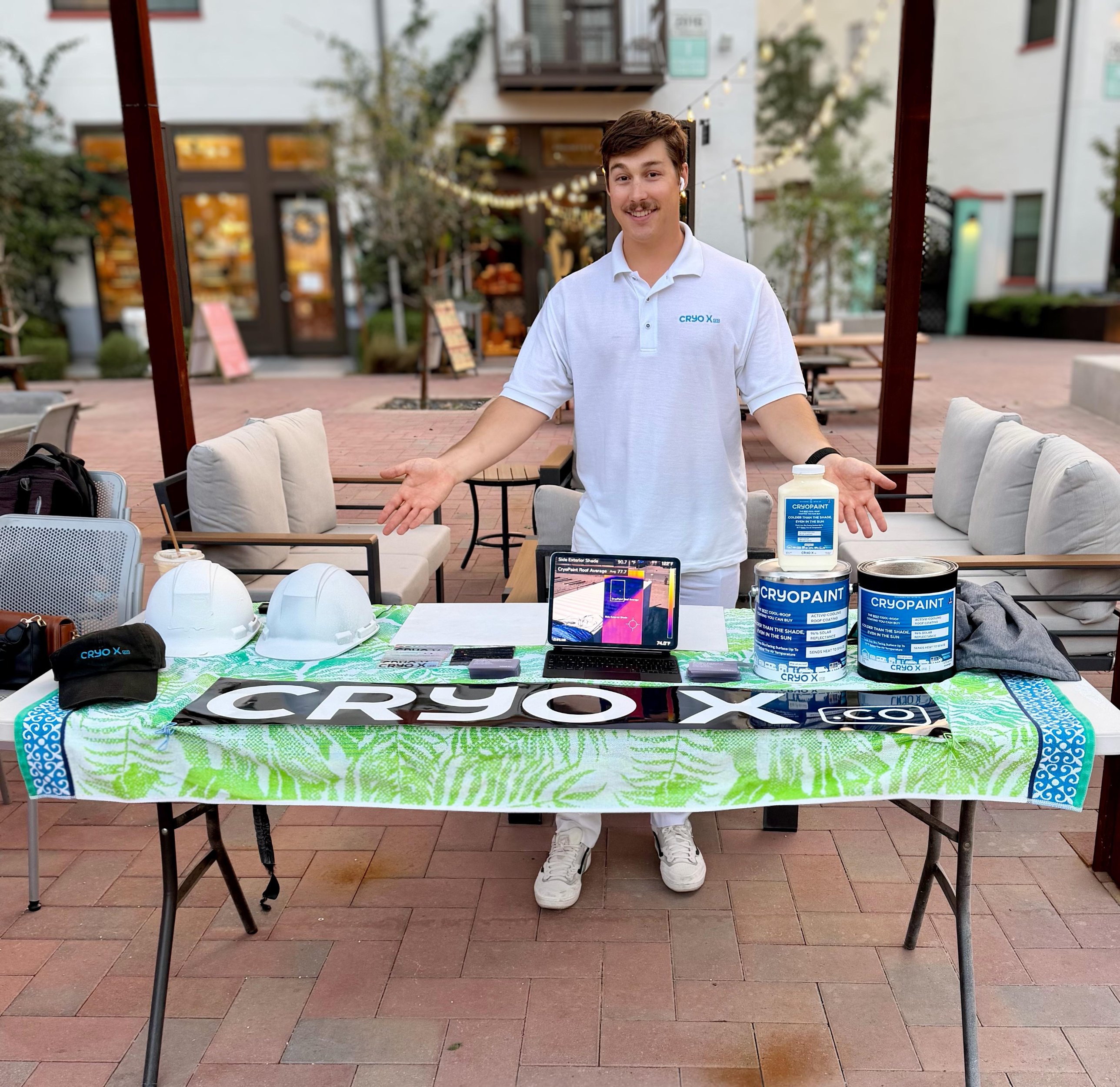 Jordan Fourcher at a Cryo X pop-up table with CryoPaint cans and a thermal camera demo