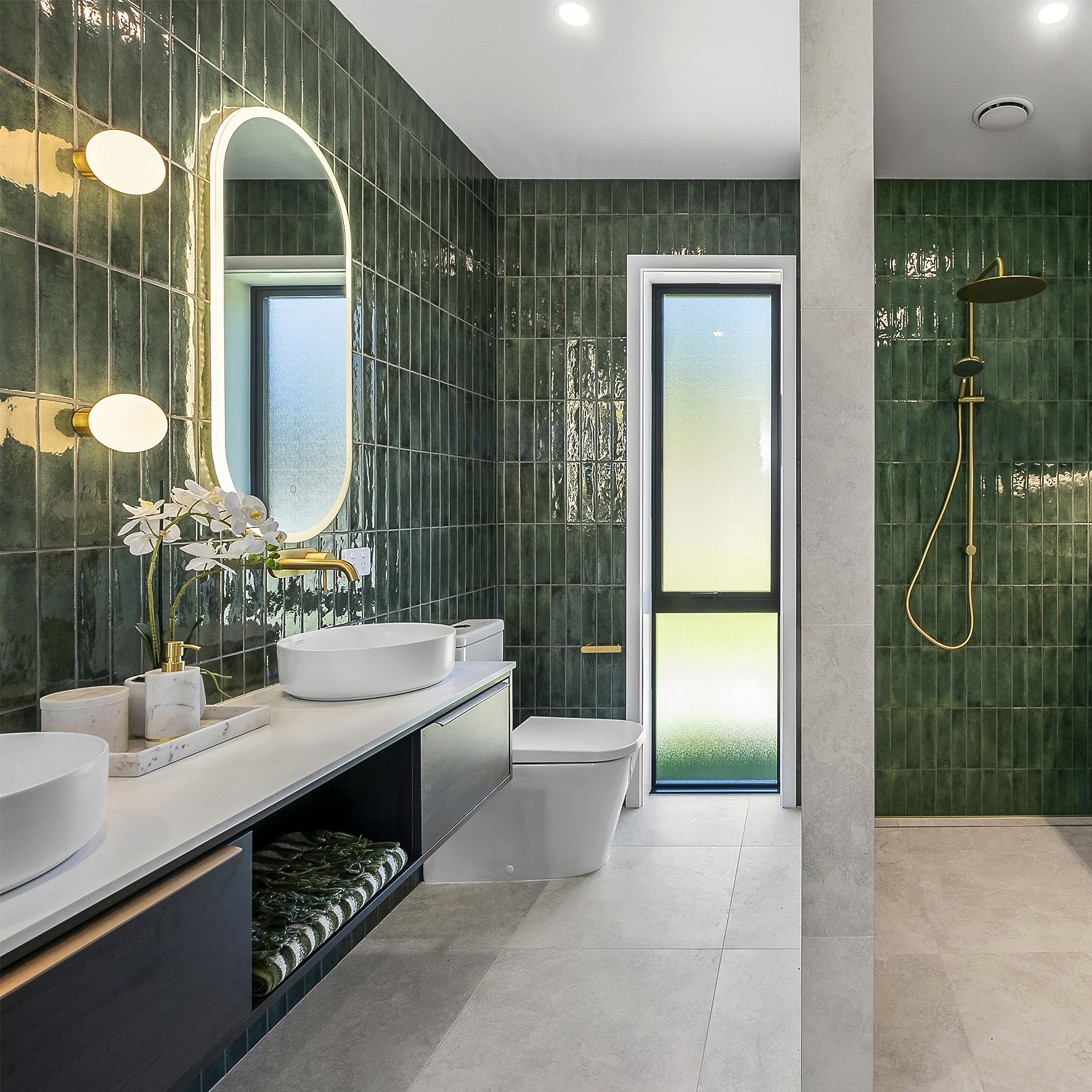 Athletic man in a sleeveless black outfit posing confidently outdoors under a bright blue sky, with a close-up of navy and salmon-colored men’s running shoes in the foreground.