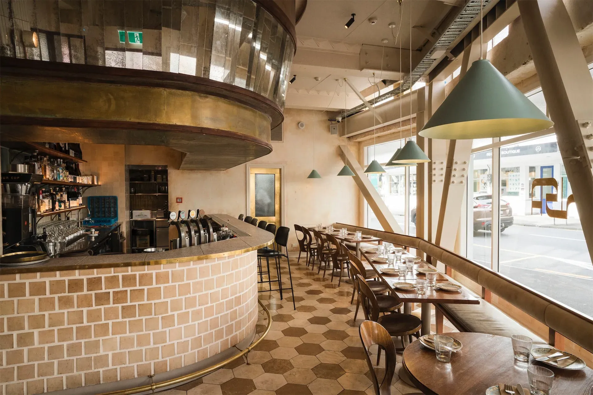 A hand lifting the first slice of a pizza on a marble table