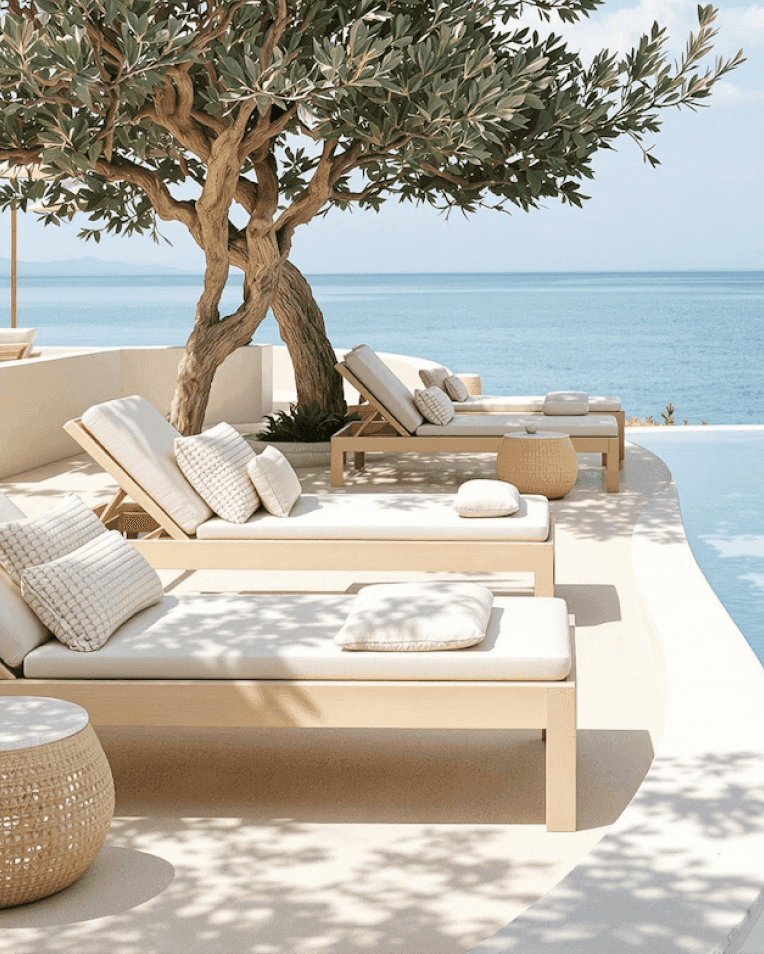 Luxury cabana by the sea with white curtains, sunbed, and infinity pool.