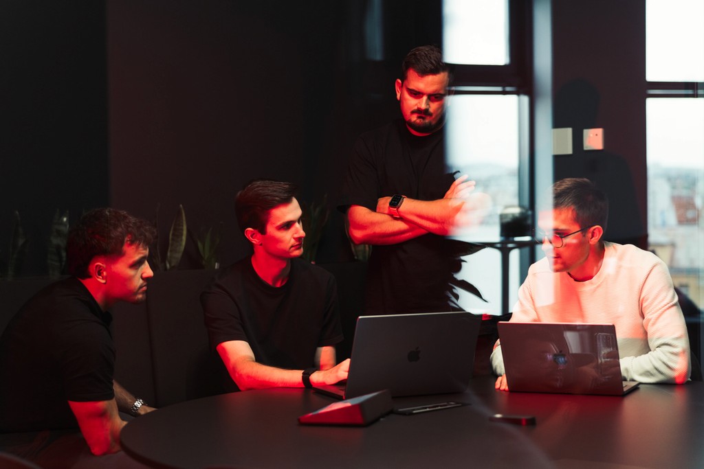 Close-up of a human eye illuminated by red light, symbolizing AI vision and digital innovation.