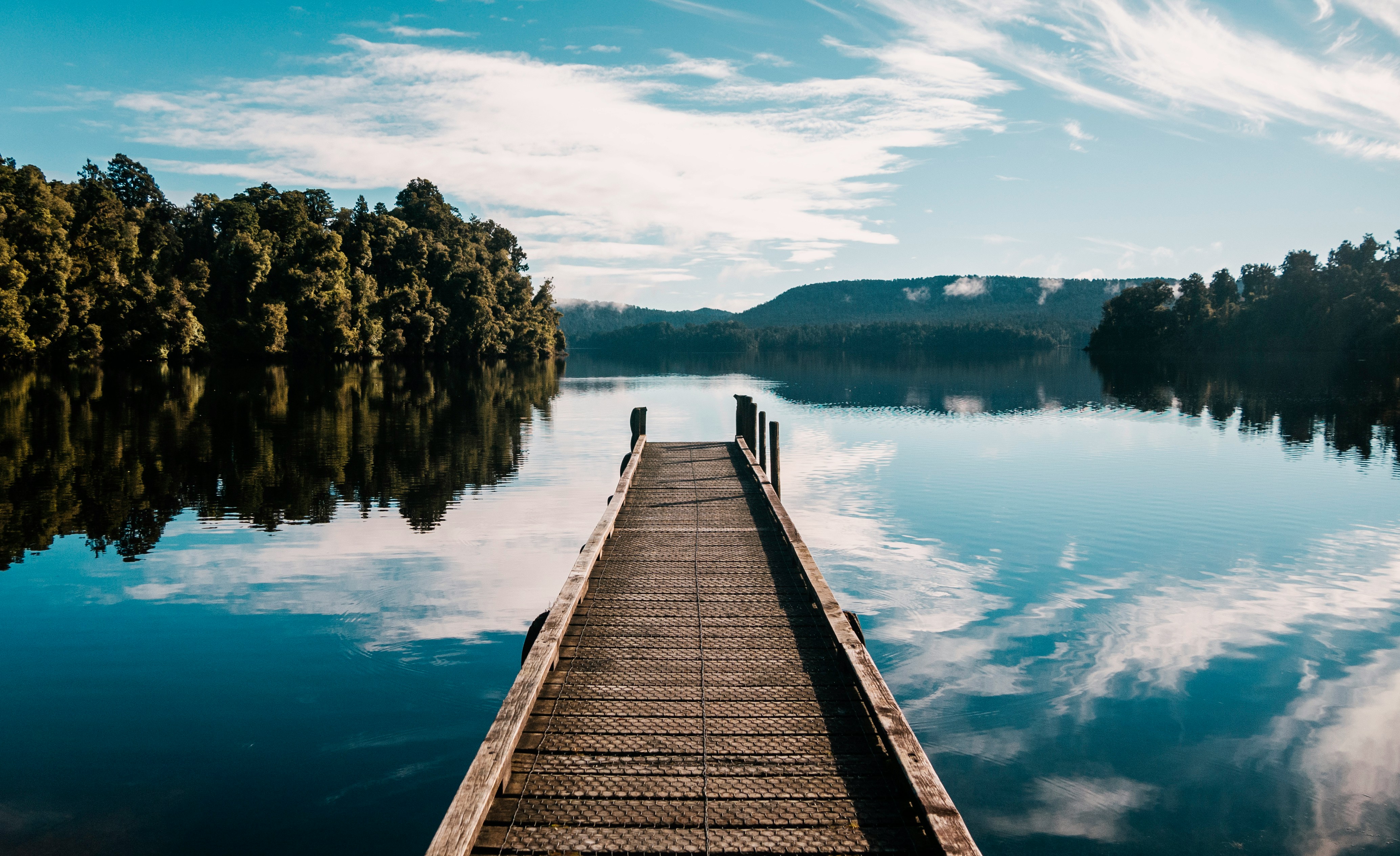 A wooden dock reaching into a calm lake