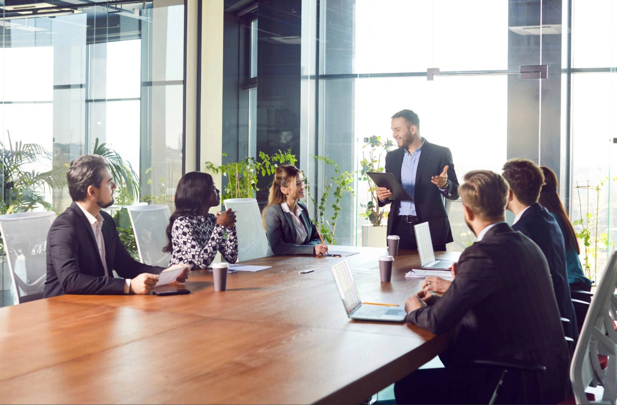 woman sitting around table holding tablet