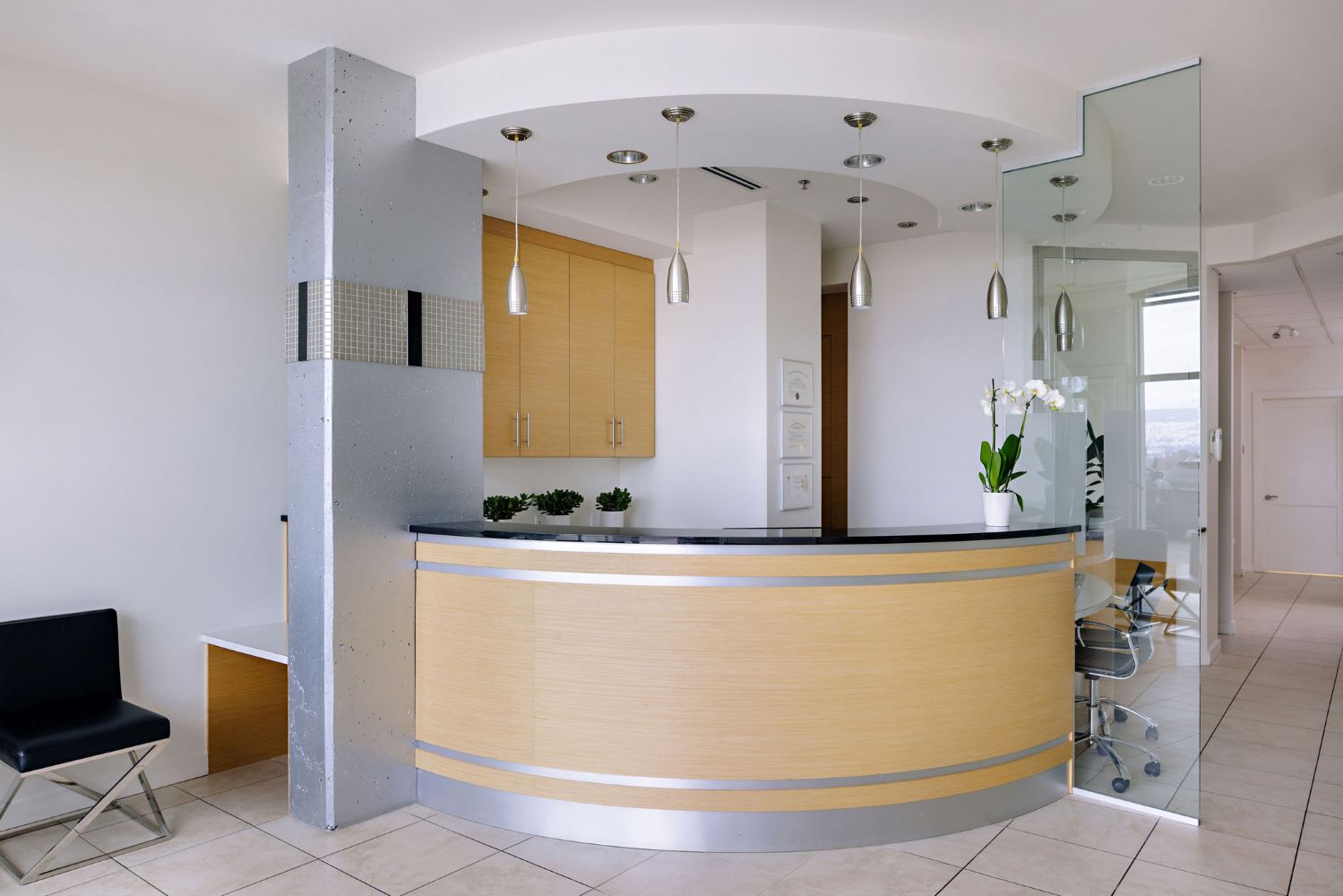 Alpha Dental office reception area with wooden desk and decorative lighting.