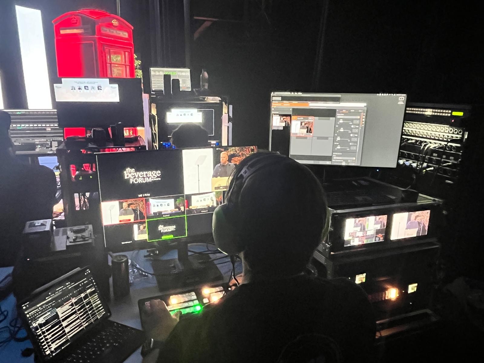 selective photo of camera with tripod and laptop computer turned on