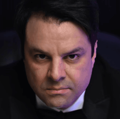 Profile portrait of a man in a grey shirt