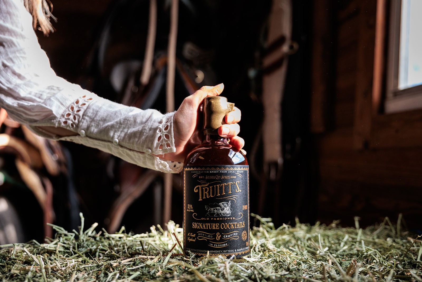 Woman holding a bottle of Truitt's
