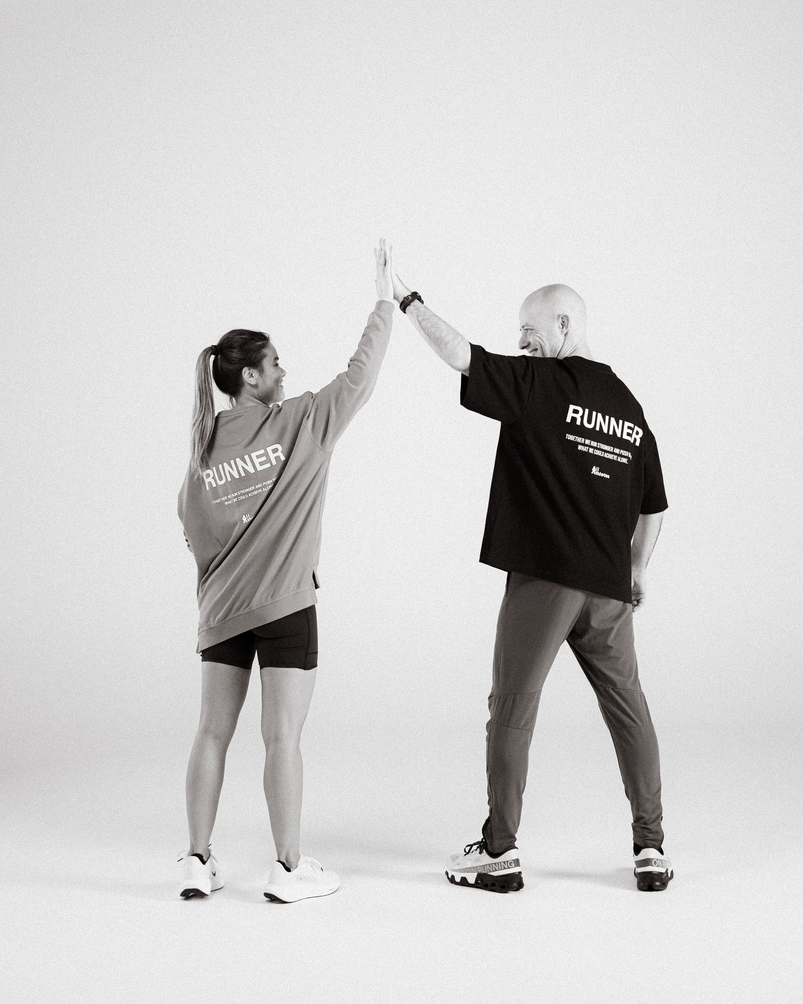 Black and white image of people working at a table with laptops, showing hands gesturing during discussion of digital content displayed on screens, with fabrica® logo in the corner.