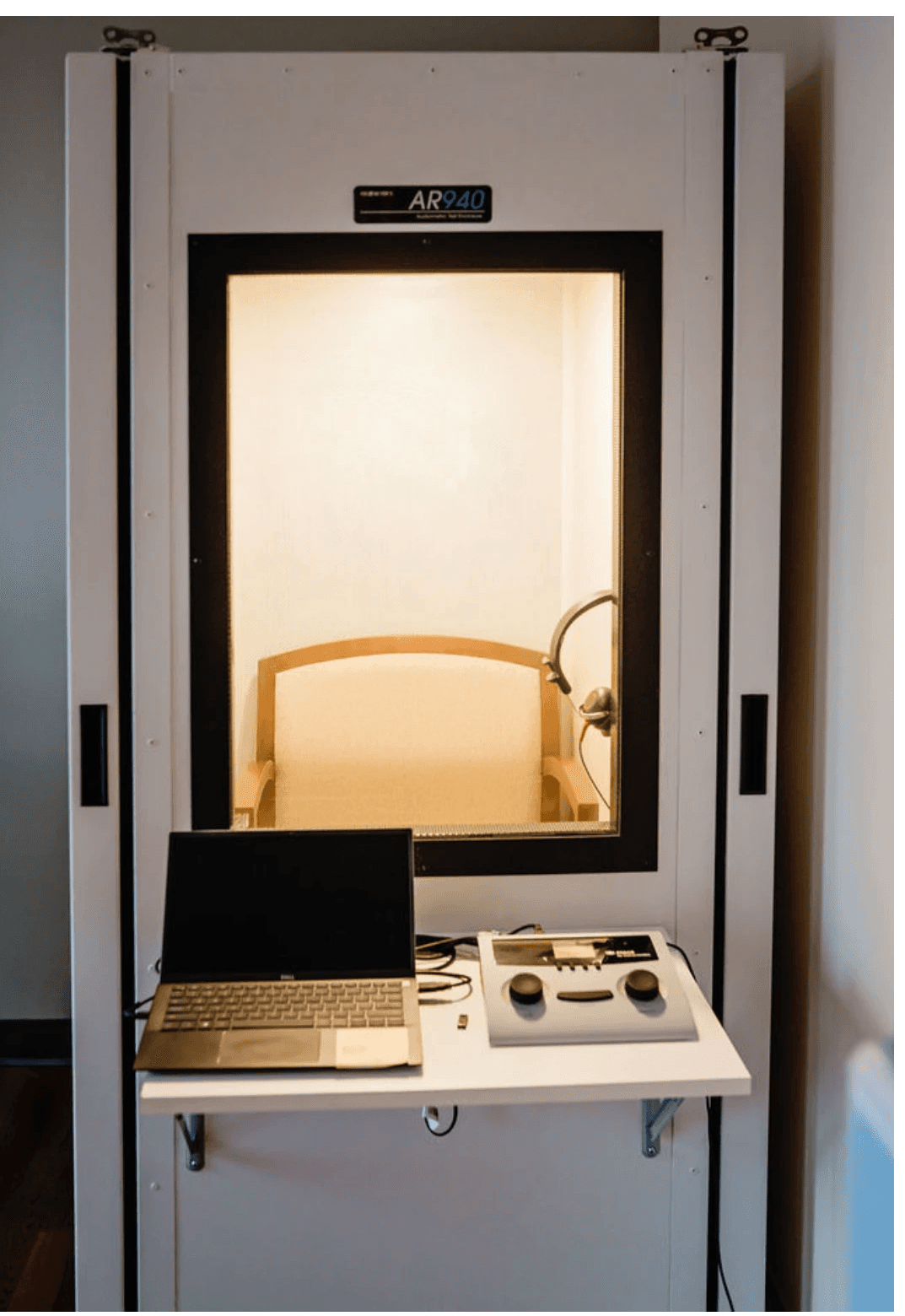 Private, sound-proof testing booth used for hearing assessments at Harper Health clinic.