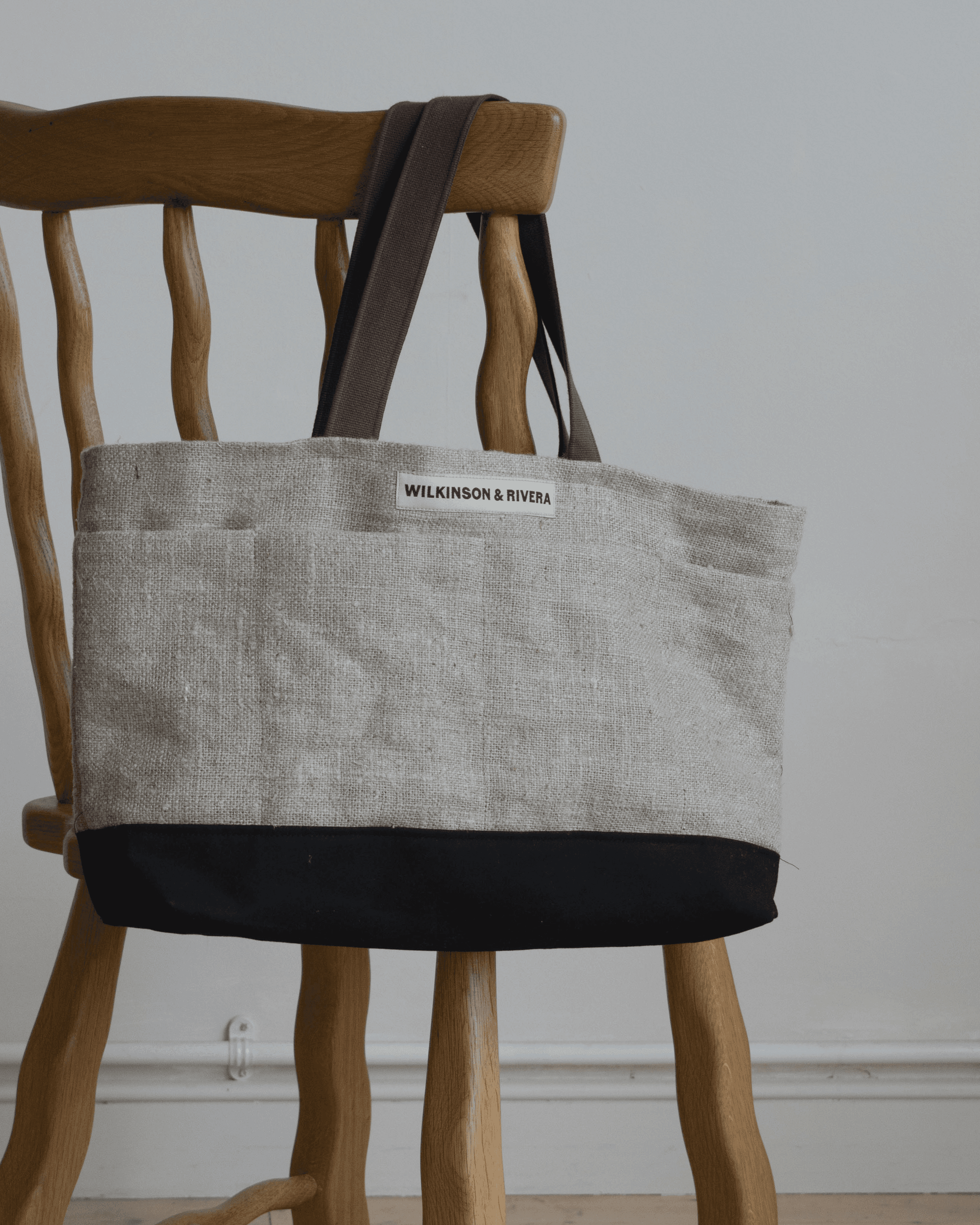 Limited edition Garden Tote from Wilkinson & Rivera in Raw Linen hanging from chair