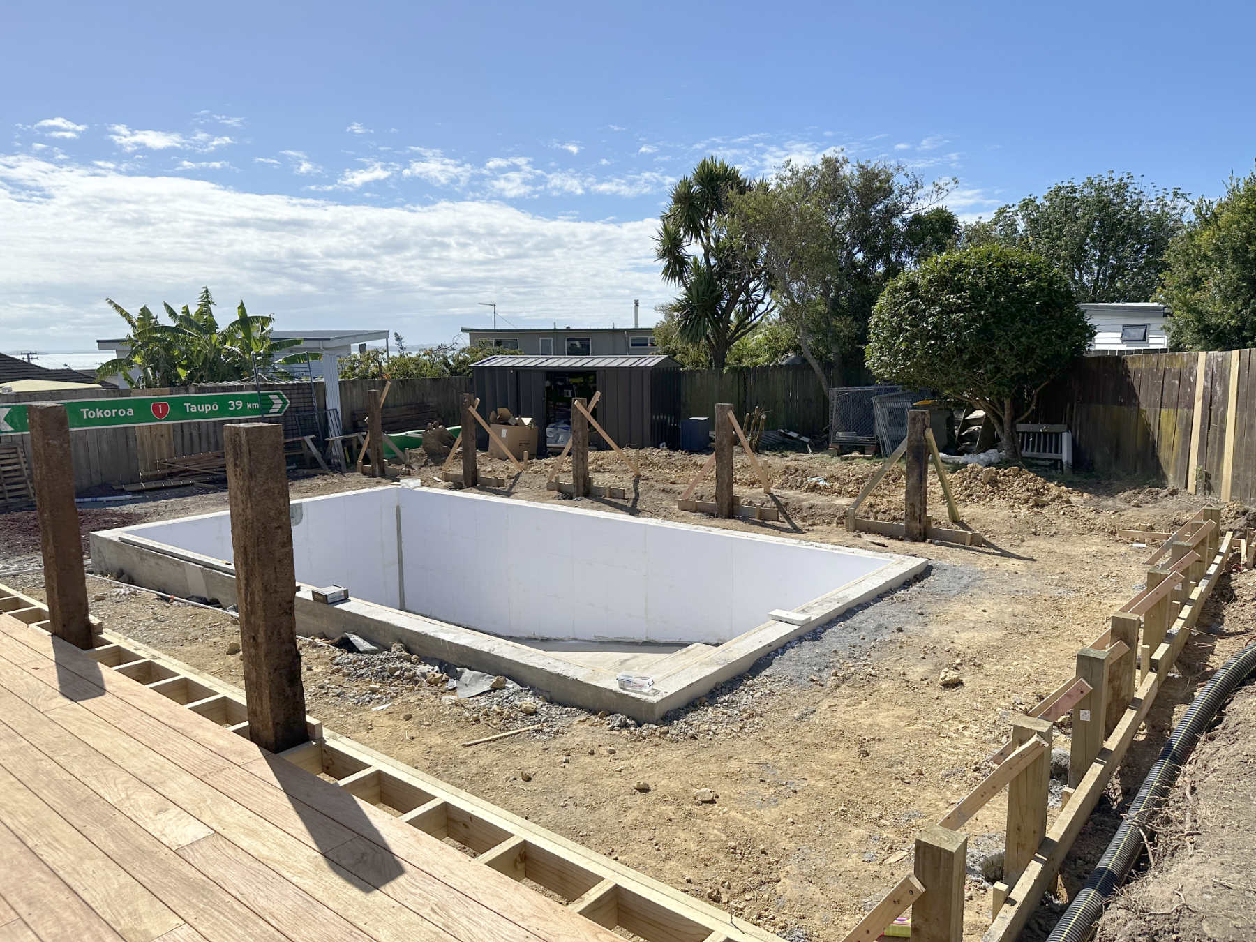 Outdoor area before the exterior area had been installed, with a pool, fencing and deck, Maraetai, East Auckland builder