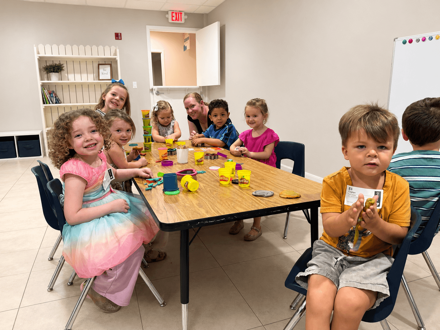 Children enjoying a Play-Doh activity in a New Hope Kids classroom