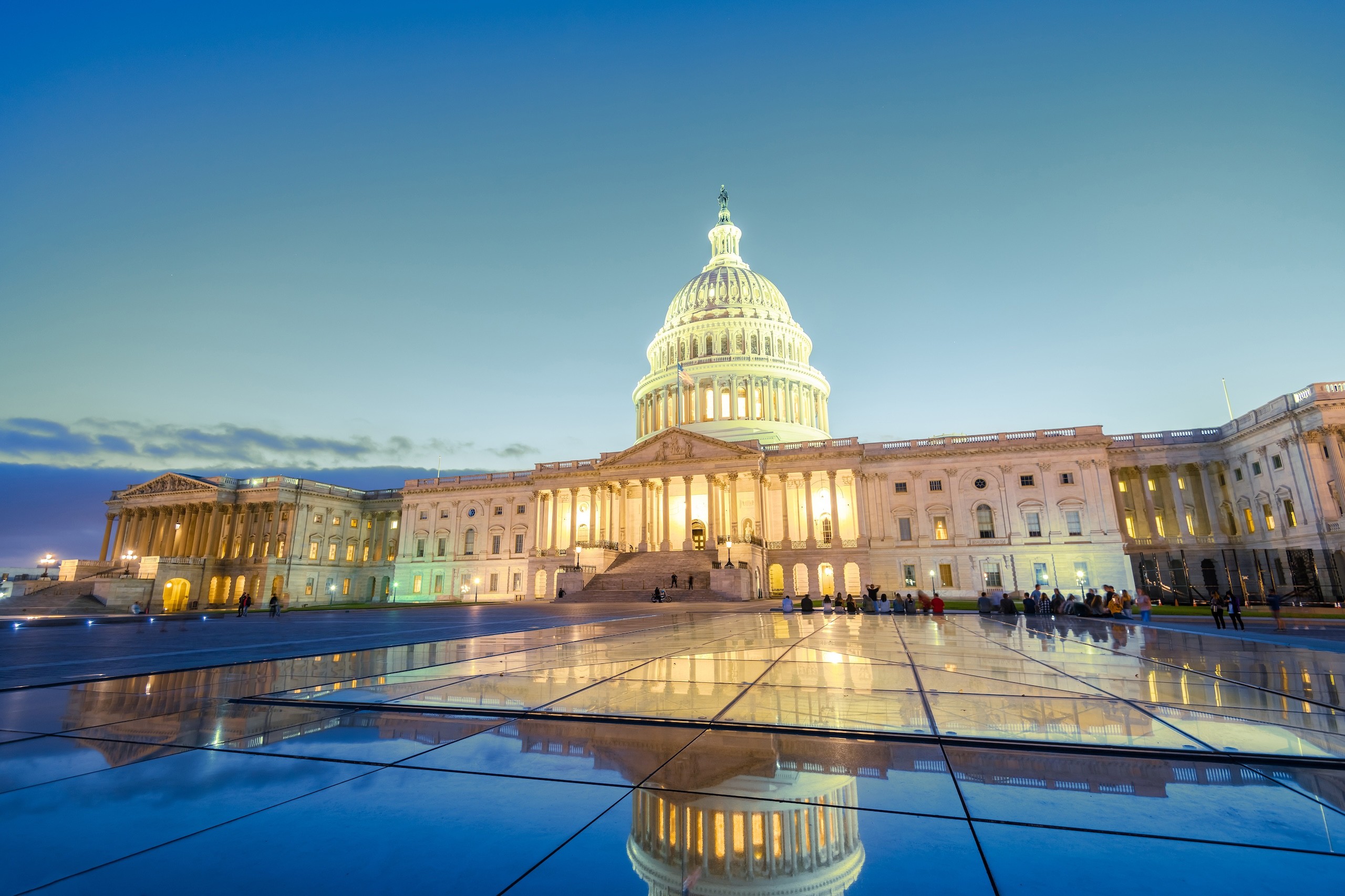 five children smiling while doing peace hand sign