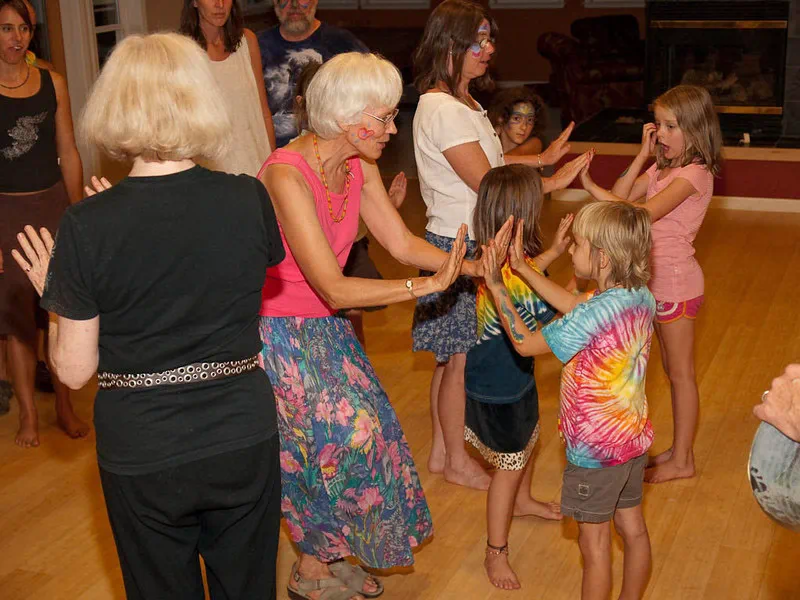 People of different ages dancing together in a shared community space.