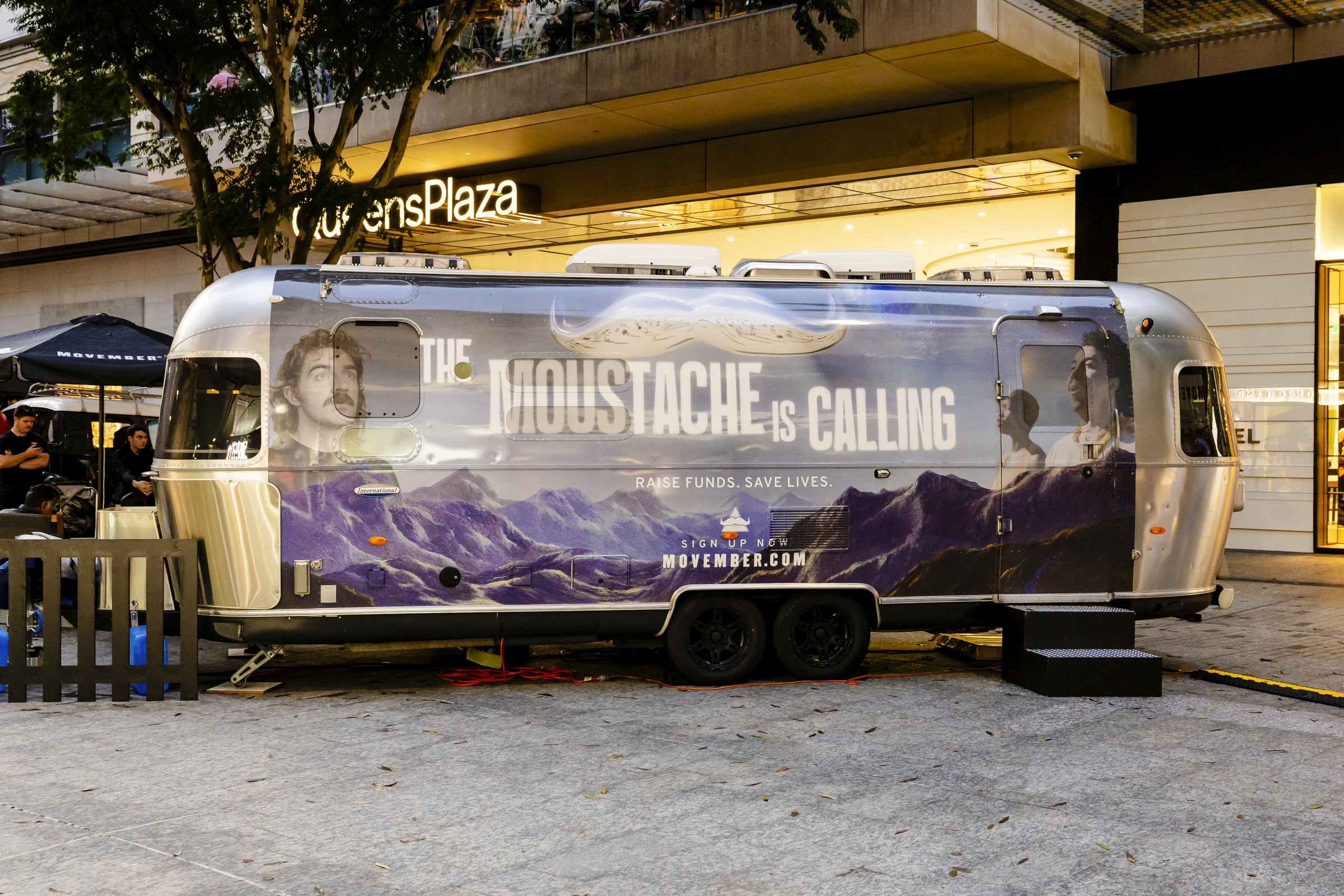Airstream trailer with Movember branding and mountains