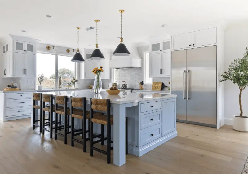 Wide shot at an angle of the kitchen showcasing the fridge area in the Dana Point Remodel. Photo by Todd Huge.