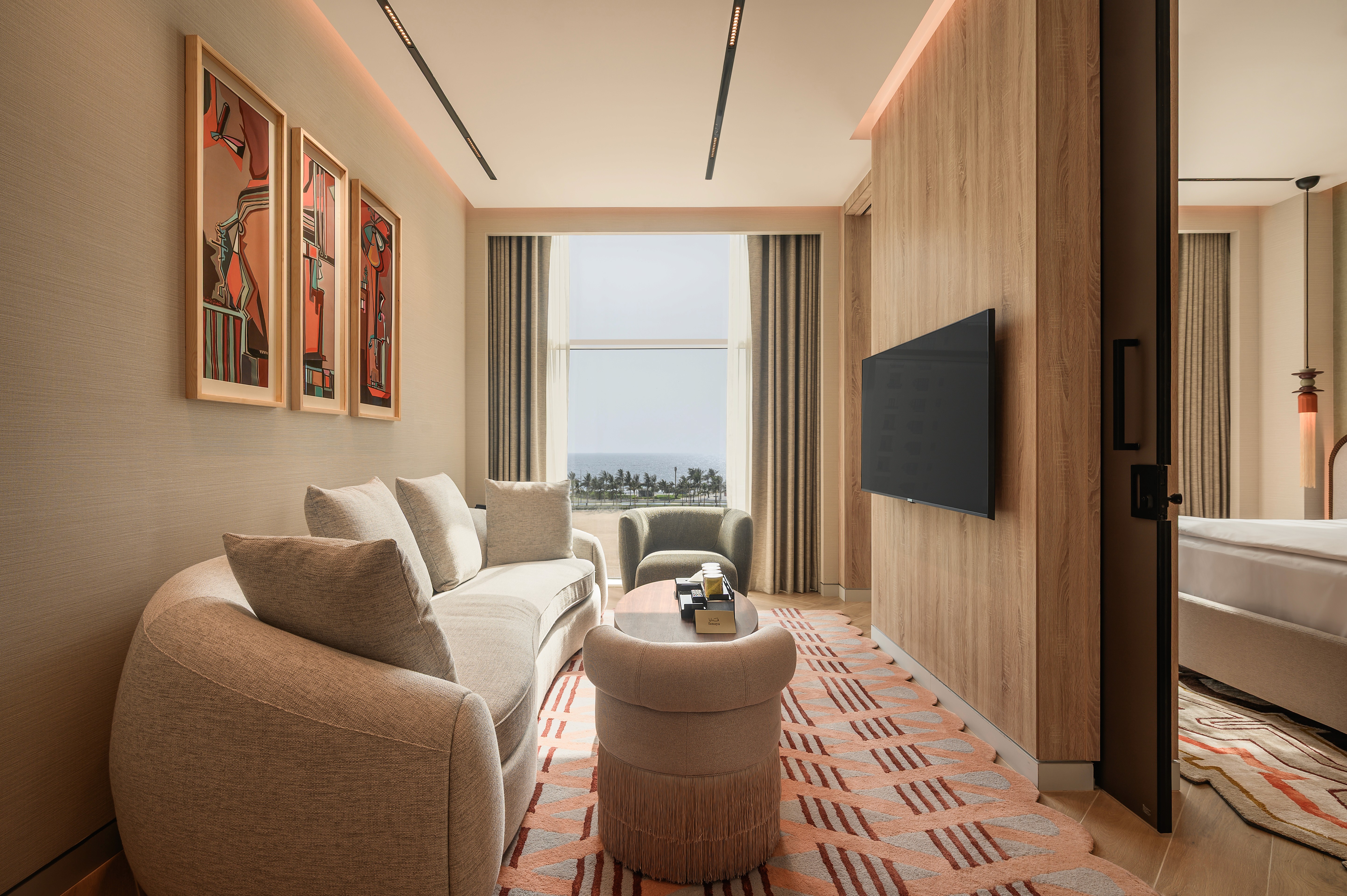 Outdoor lounge under a wooden pergola, draped linen curtains, beige cushions, ocean backdrop, palm shadows dancing on the walls, serene luxury.