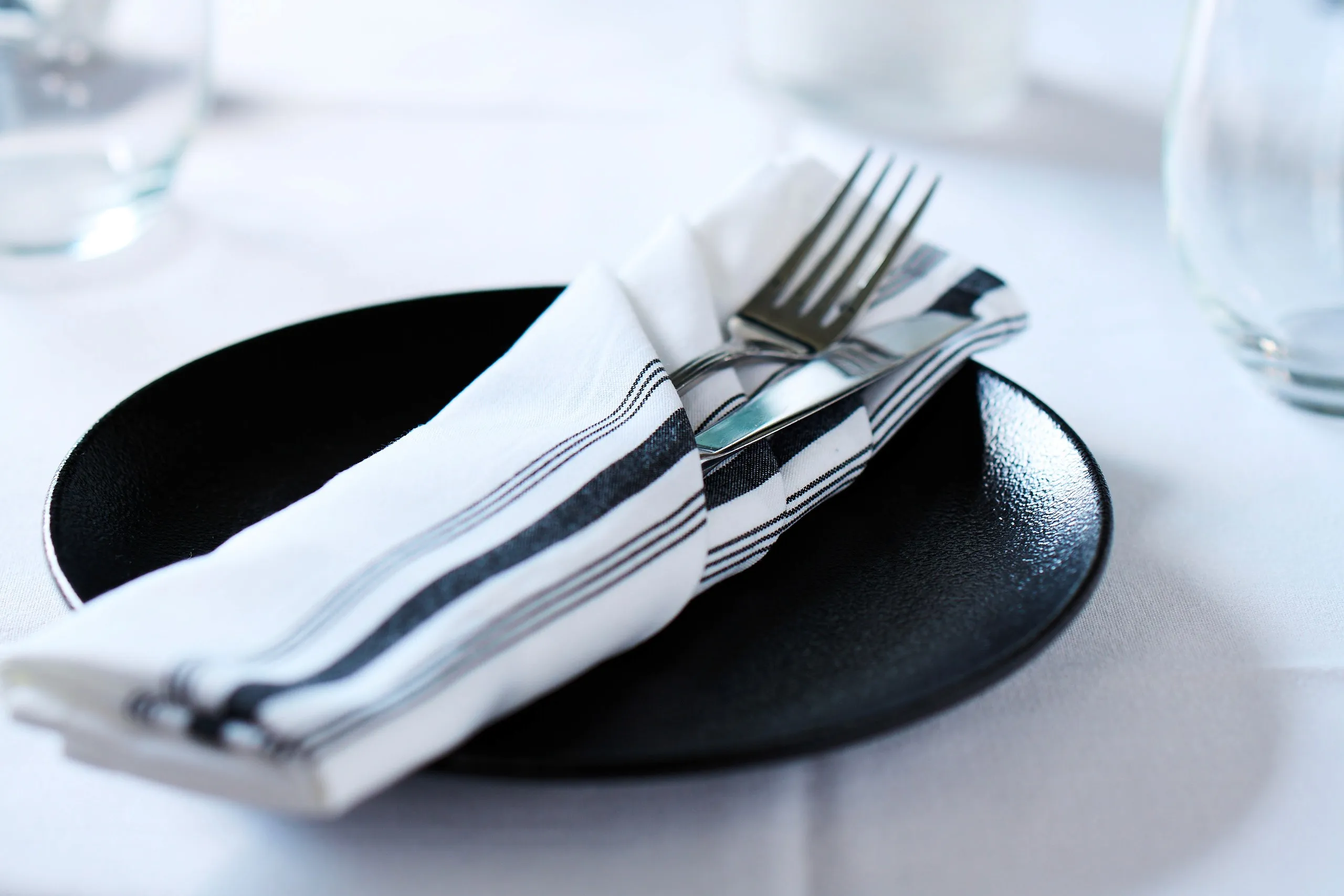 Elegant place setting with folded napkin and silverware for special celebrations.