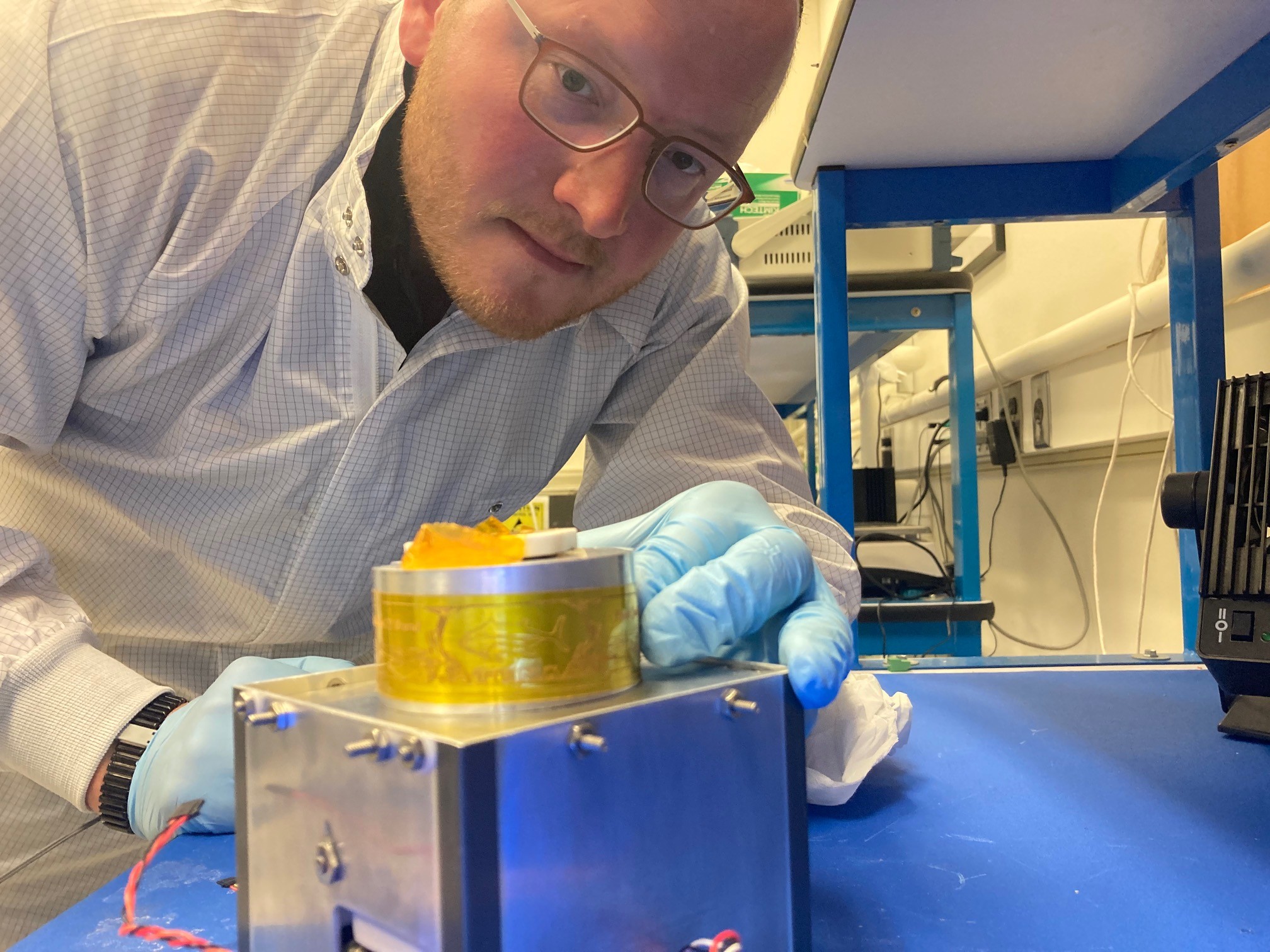 engineer attaching label to satellite