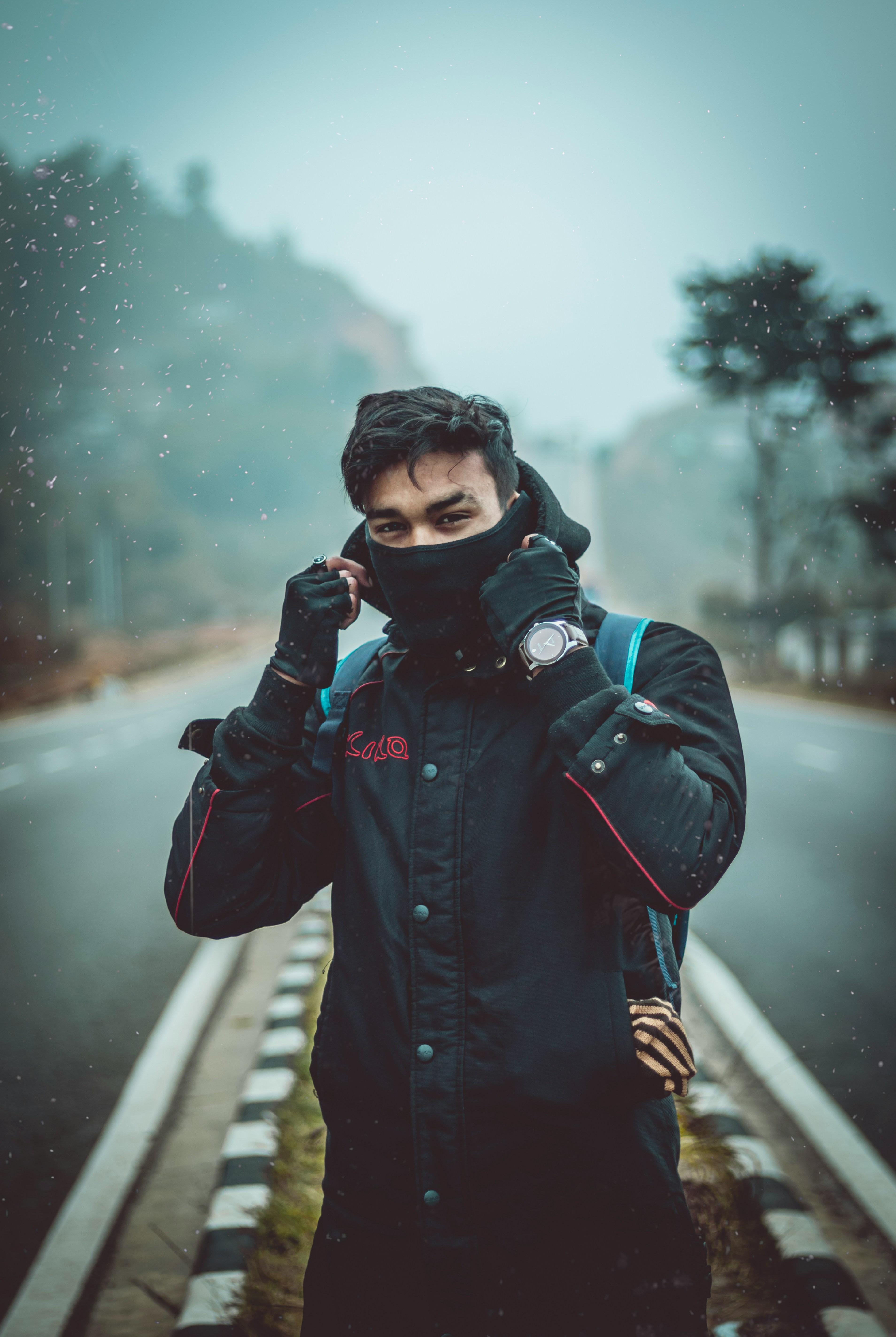 man wearing black hooded jacket