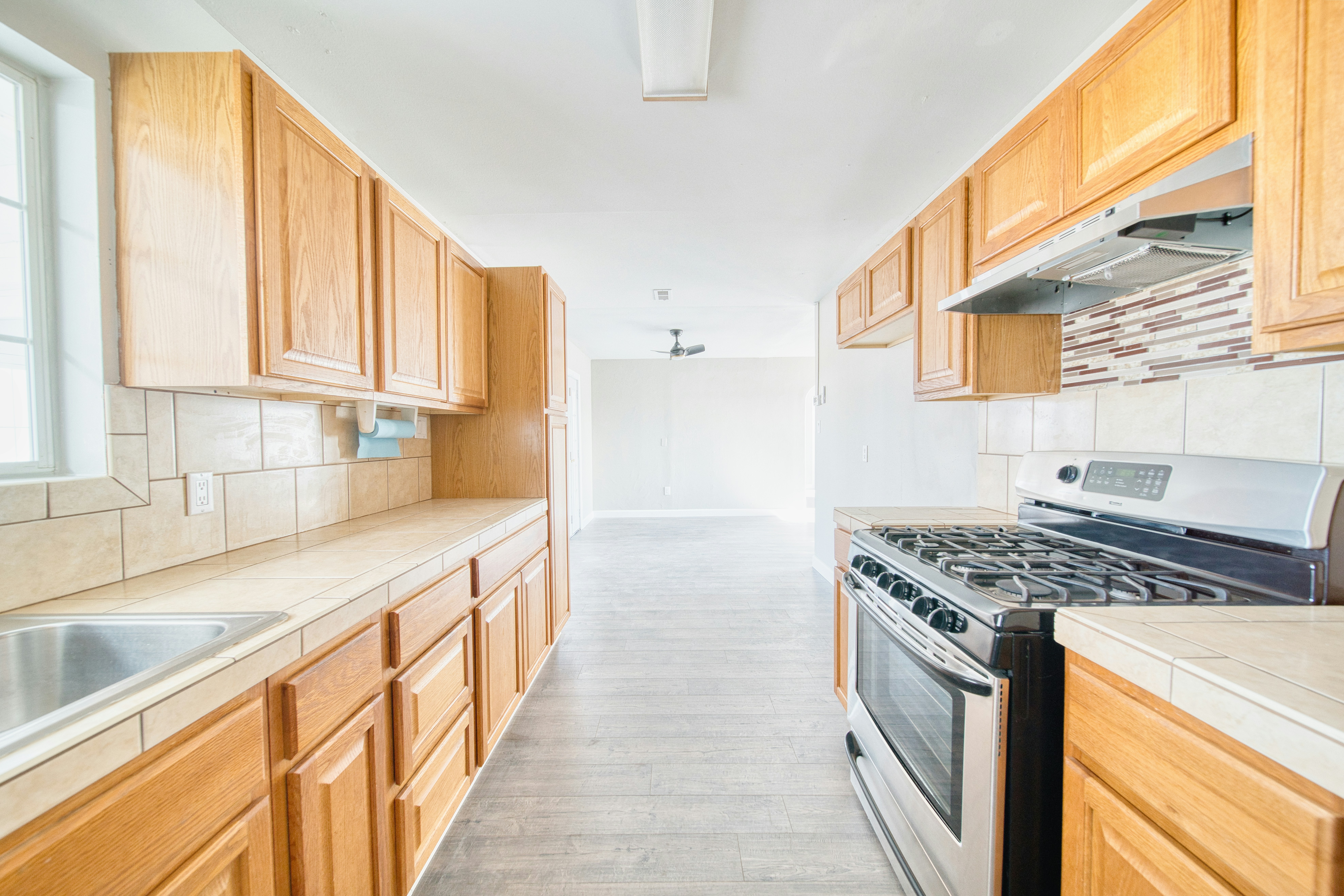 A kitchen with a stove top oven next to a sink