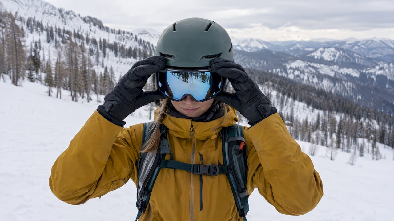 Skier adjusting goggles before a mountain outing