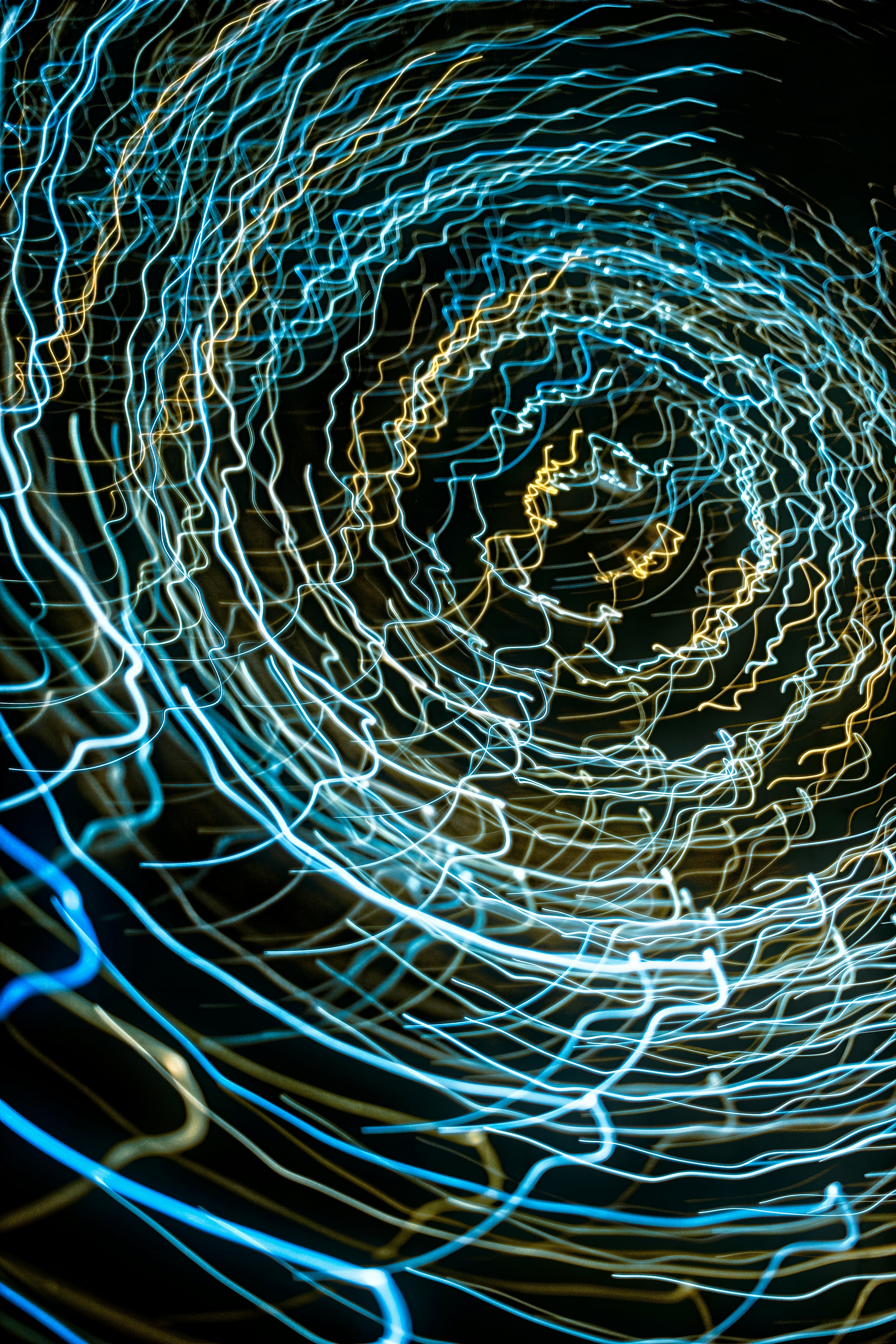 Abstract swirling light trails in blues and yellows